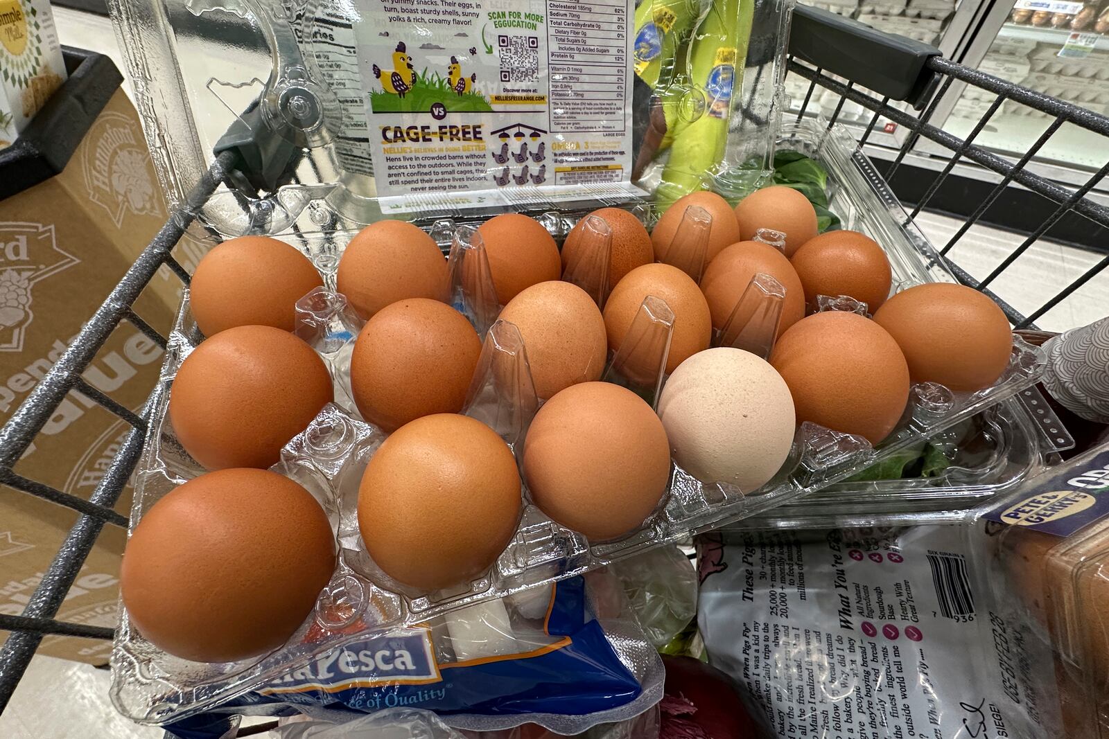 Eggs sit in a container in a shopping cart at grocery store, Monday, Jan. 27, 2025, in Windham, Maine. (AP Photo/Robert F. Bukaty)