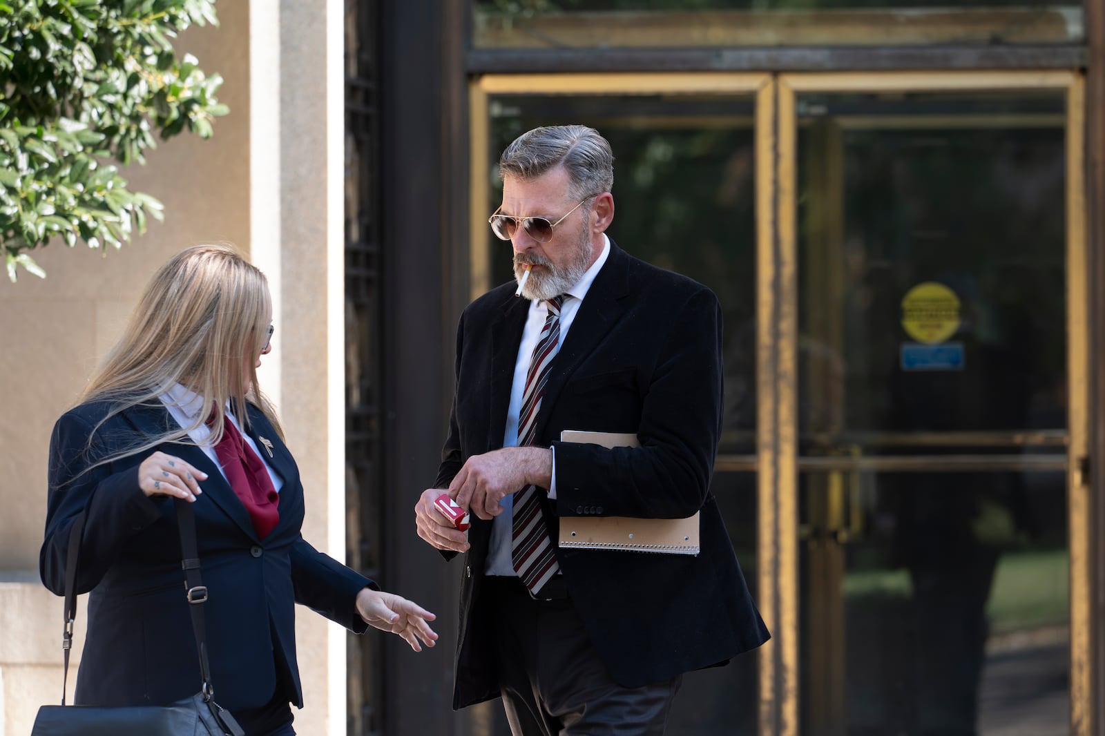 Actor Jay Johnston emerges from the U.S. District Courthouse in Washington, Monday, Oct. 28, 2024, after been sentenced to one year in prison for his part in a mob’s attack on the U.S. Capitol nearly four years ago. Johnston joined other rioters in a “heave ho” push against police officers guarding a tunnel entrance to the Capitol during the Jan. 6, 2021, riot. (AP Photo/J. Scott Applewhite)