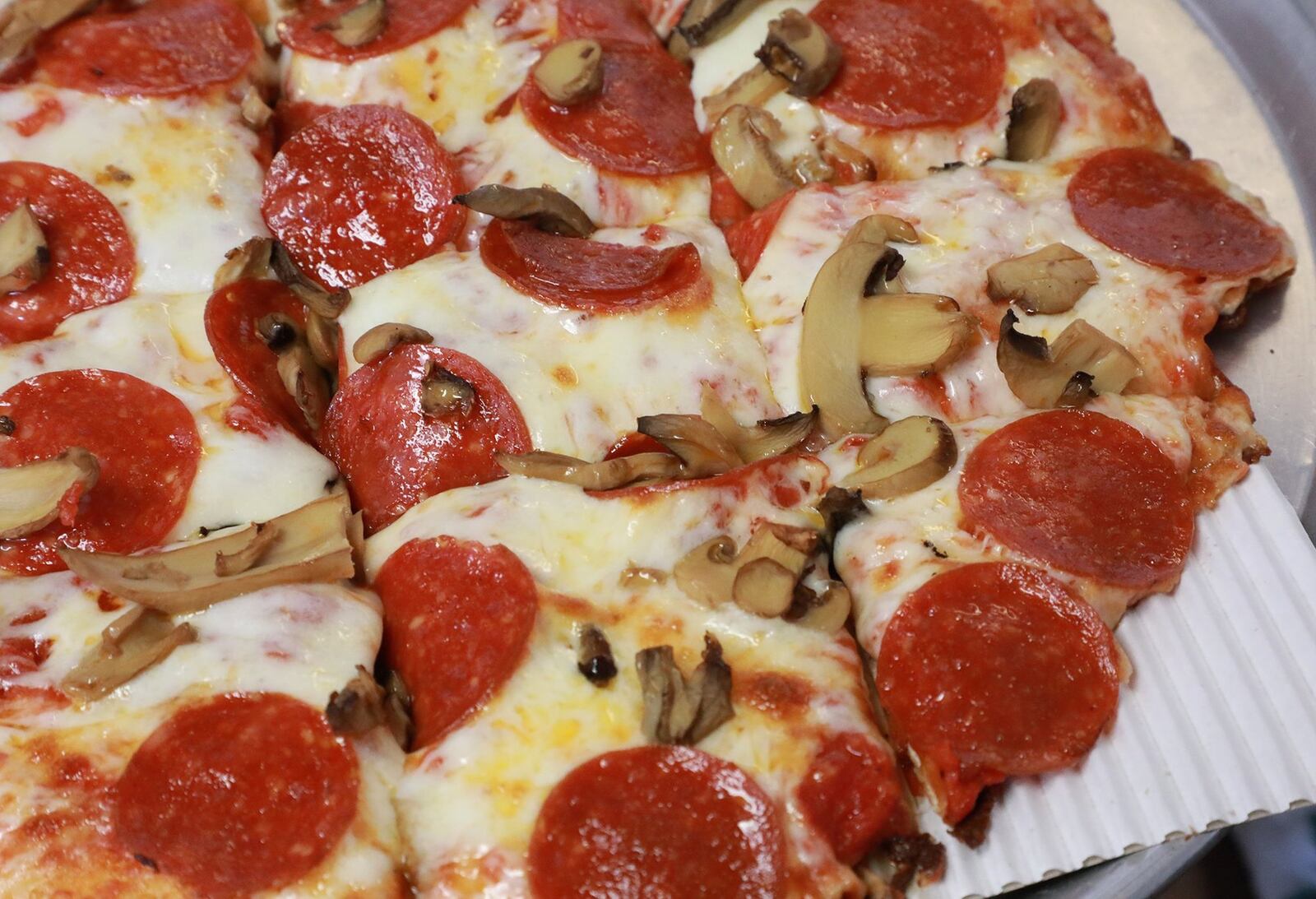 A pepperoni and mushroom pizza fresh from the oven at Short Stop. BILL LACKEY/STAFF