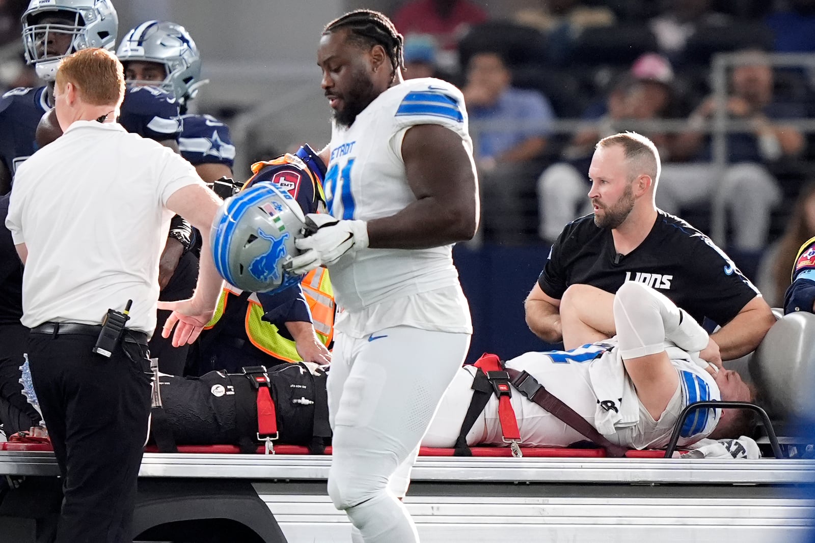 Detroit Lions defensive end Aidan Hutchinson is carted off the field after suffering an unknown injur in the second half of an NFL football game against the Dallas Cowboys in Arlington, Texas, Sunday, Oct. 13, 2024. (AP Photo/LM Otero)