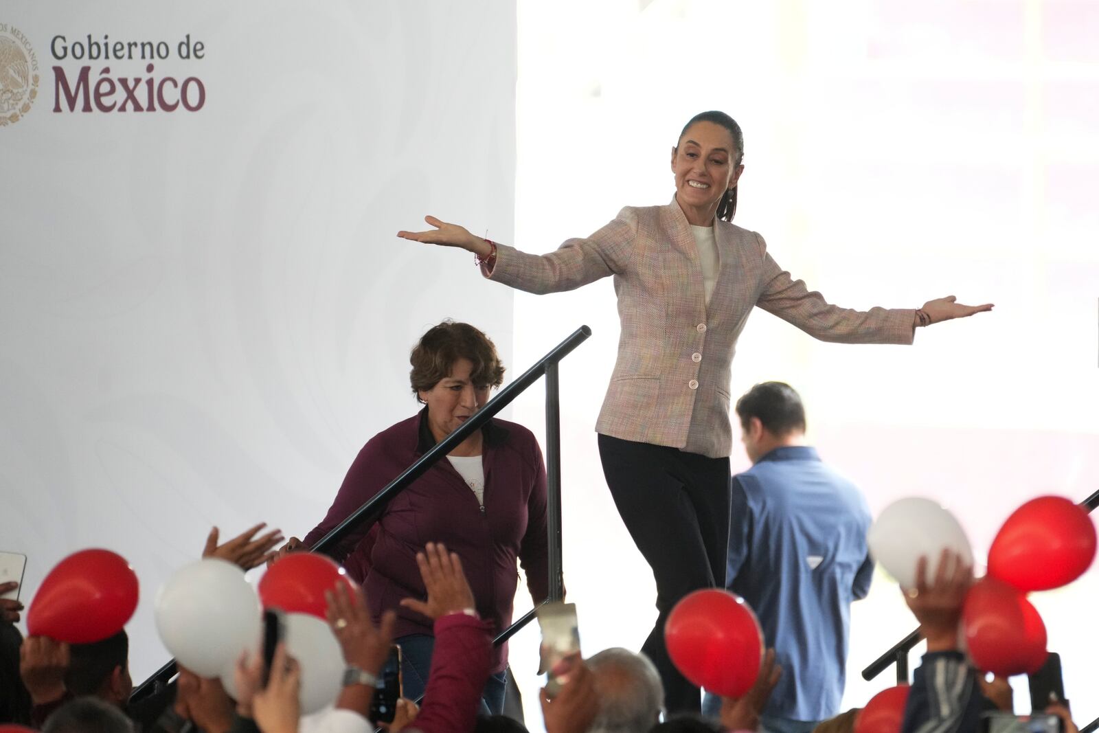 FILE - Mexican President Claudia Sheinbaum greets guests as she arrives for a Housing for Wellbeing even, in Mexico City, Feb. 1, 2025. (AP Photo/Marco Ugarte, File)