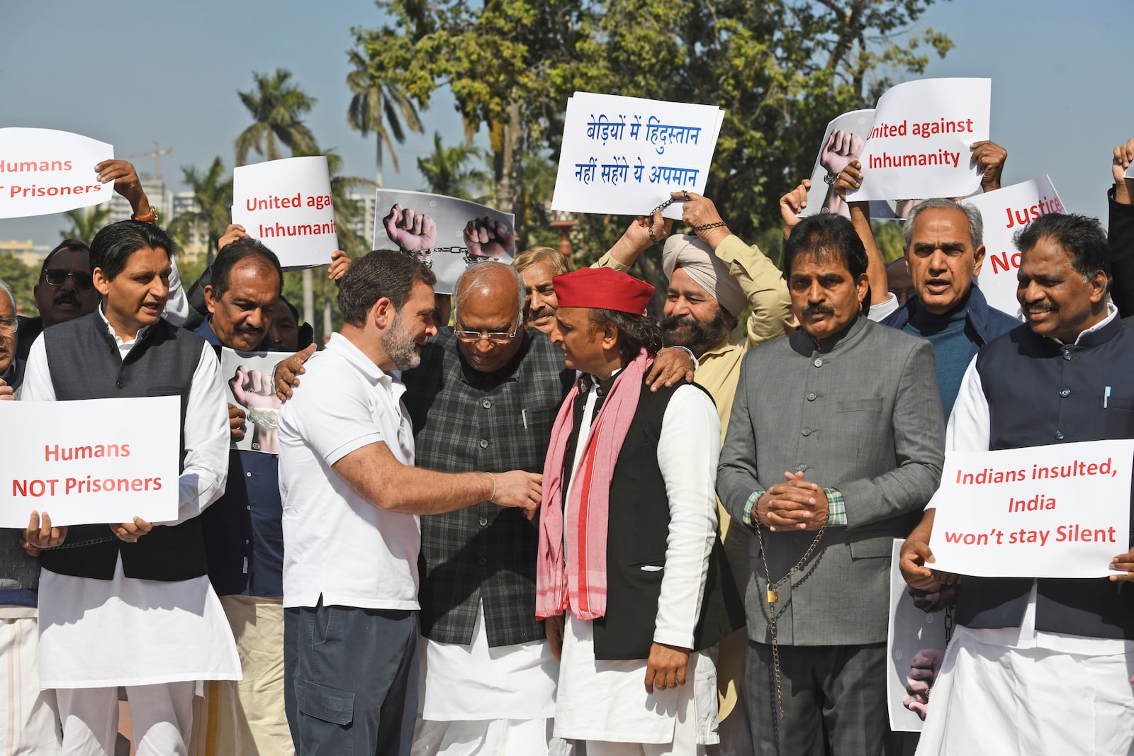 India's opposition lawmakers, some of them wearing shackles, stage a protest outside the Parliament in New Delhi, to condemn the reported mistreatment of Indian immigrants during their deportation from the United States, Thursday, Feb.6, 2025. The banners in Hindi language read "Indians in shackles, will not tolerate the insult." (AP Photo)