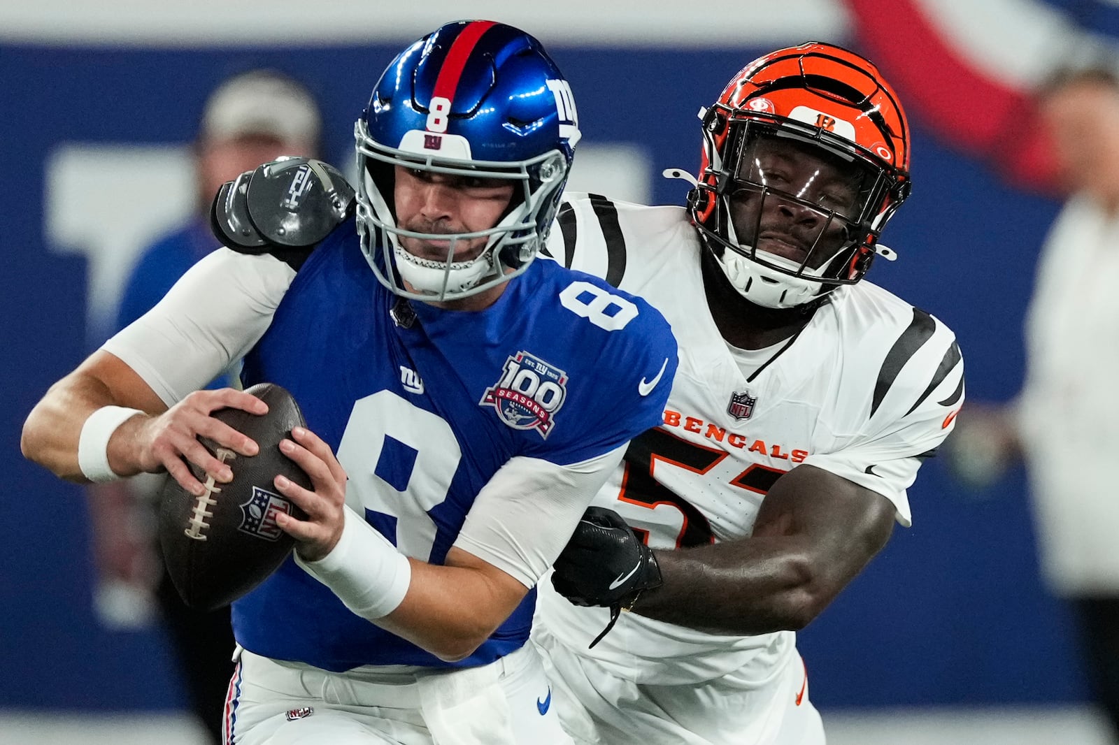 New York Giants quarterback Daniel Jones (8) escapes from Cincinnati Bengals defensive end Isaiah Thomas (51) during the first half of an NFL football game, Sunday, Oct. 13, 2024, in East Rutherford, N.J. (AP Photo/Seth Wenig)