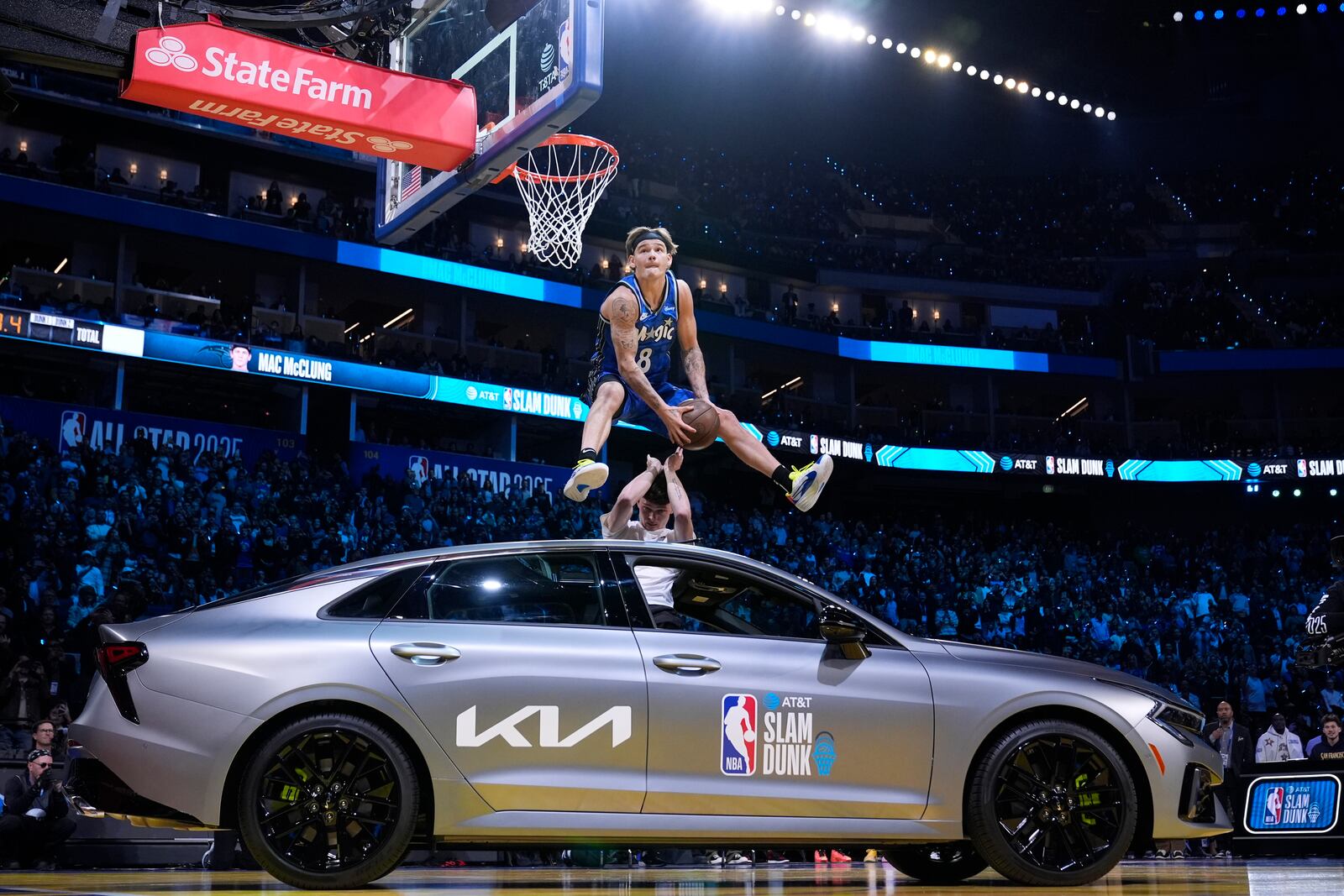 Orlando Magic guard Mac McClung dunks over a car during the slam dunk contest at the NBA basketball All-Star Saturday night festivities Saturday, Feb. 15, 2025, in San Francisco. (AP Photo/Godofredo A. Vásquez)