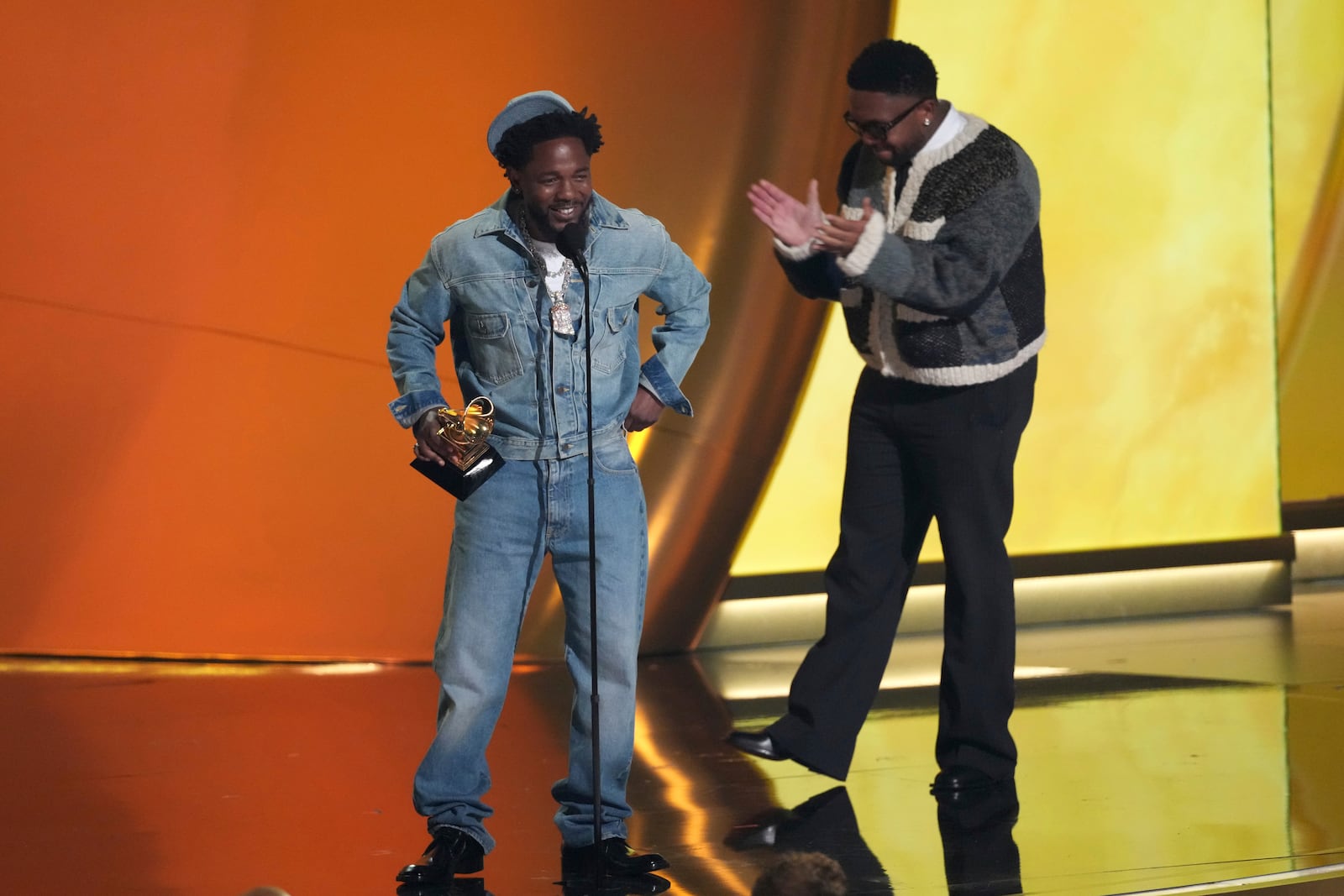 Kendrick Lamar, left, accepts the record of the year award for "Not Like Us during the 67th annual Grammy Awards on Sunday, Feb. 2, 2025, in Los Angeles. Mustard looks on from right. (AP Photo/Chris Pizzello)