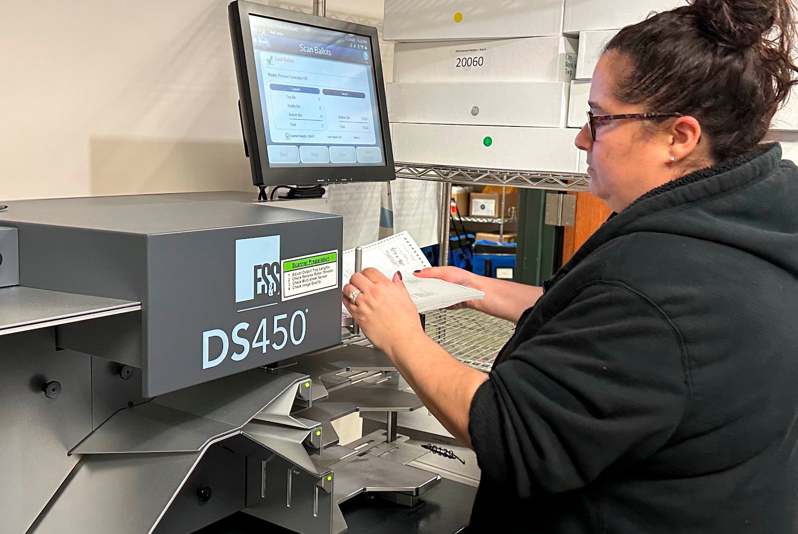 Stephanie Allen of Lehigh County Voter Services, works with a ballot tabulator in a state-mandated recount of the U.S. Senate race at the Lehigh County Government Center in Allentown, Pa., Tuesday, Nov. 19, 2024. (AP Photo/Michael Rubinkam)