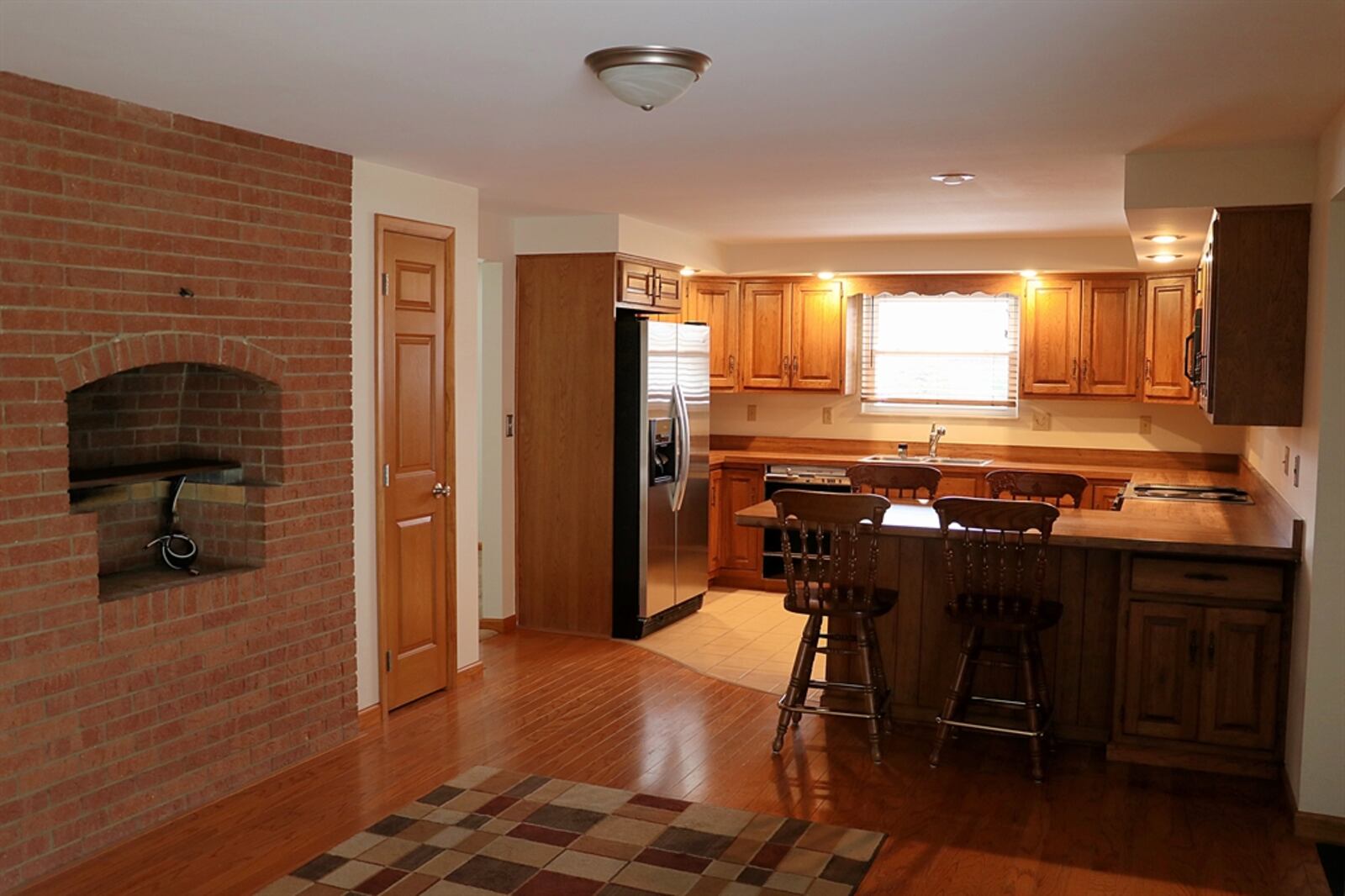 The kitchen has three walls of cabinetry, including an appliance garage and two lazy Susans.