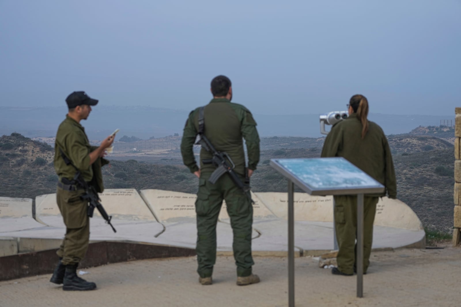 Israeli soldiers stand in an observation point overlooking the Gaza Strip from southern Israel, Thursday, Jan. 16, 2025. (AP Photo/Tsafrir Abayov)