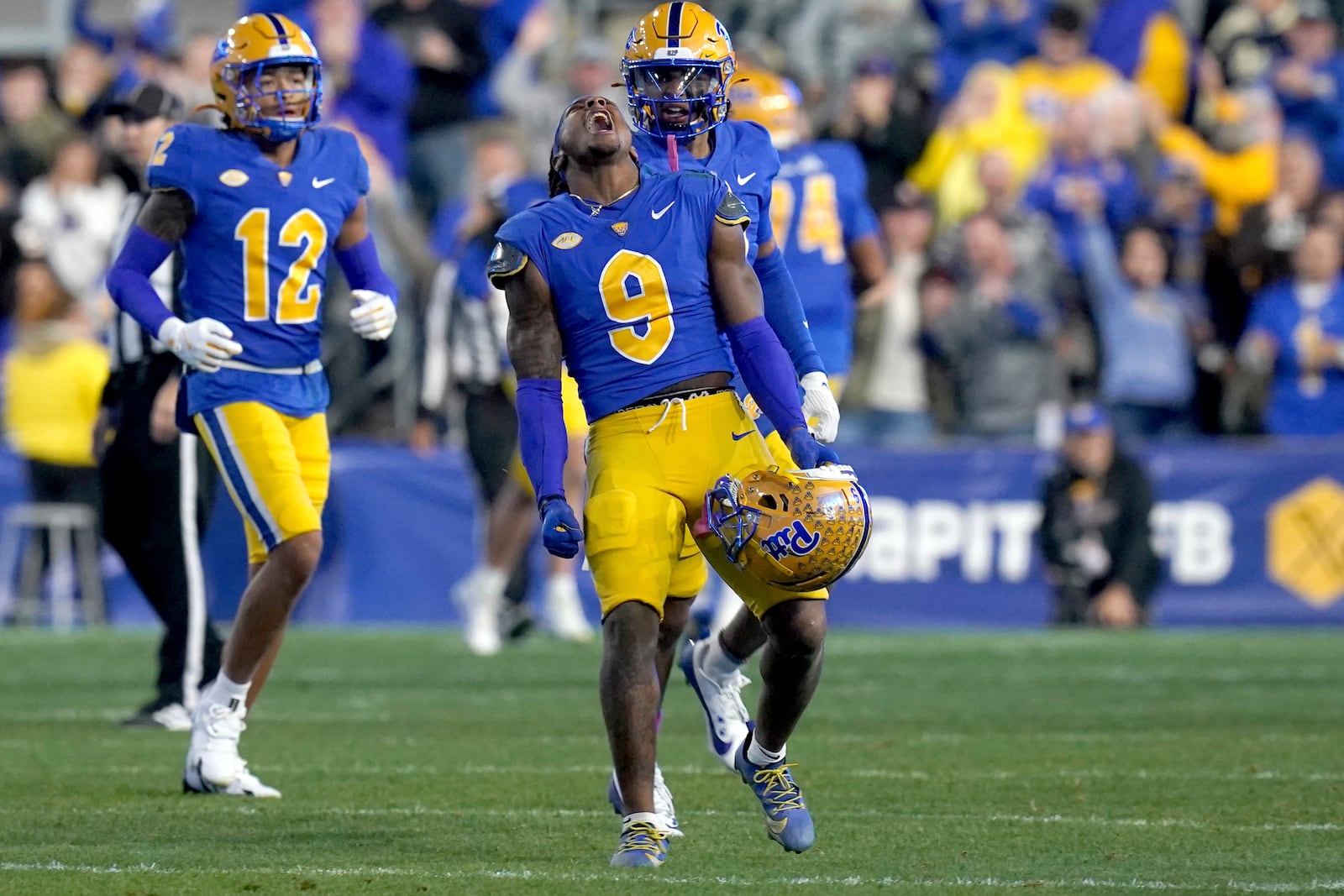 Pittsburgh linebacker Kyle Louis (9) celebrates after returning an interception for a touchdown during the first half of an NCAA college football game against Syracuse, Thursday, Oct. 24, 2024, in Pittsburgh. (AP Photo/Matt Freed)