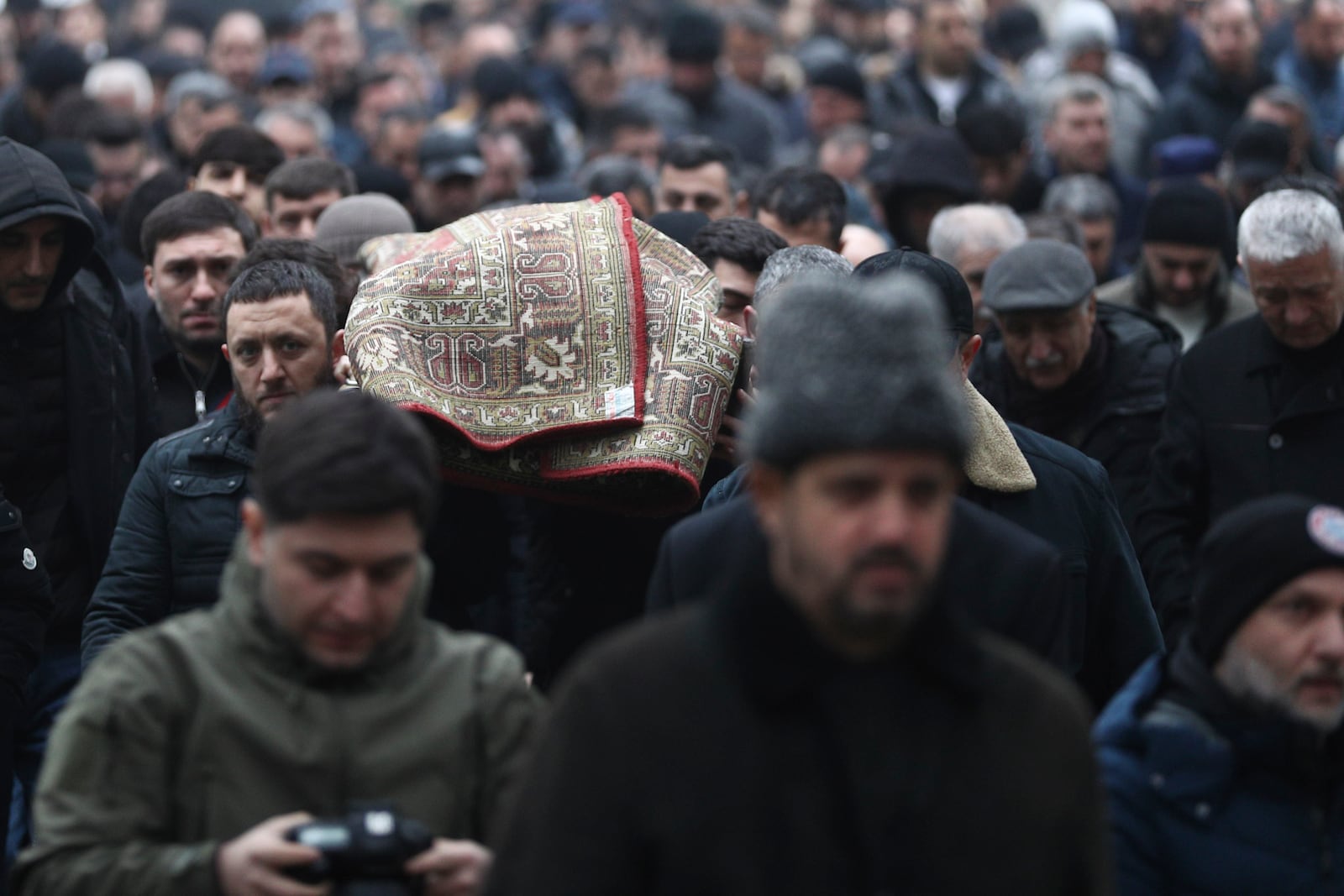 People attend the funeral of Mahammadali Eganov, 13 who died in the Azerbaijan Airlines Embraer 190 crash near Kazakhstan's Aktau airport, in Baku, Azerbaijan, Saturday, Dec. 28, 2024. (AP Photo)