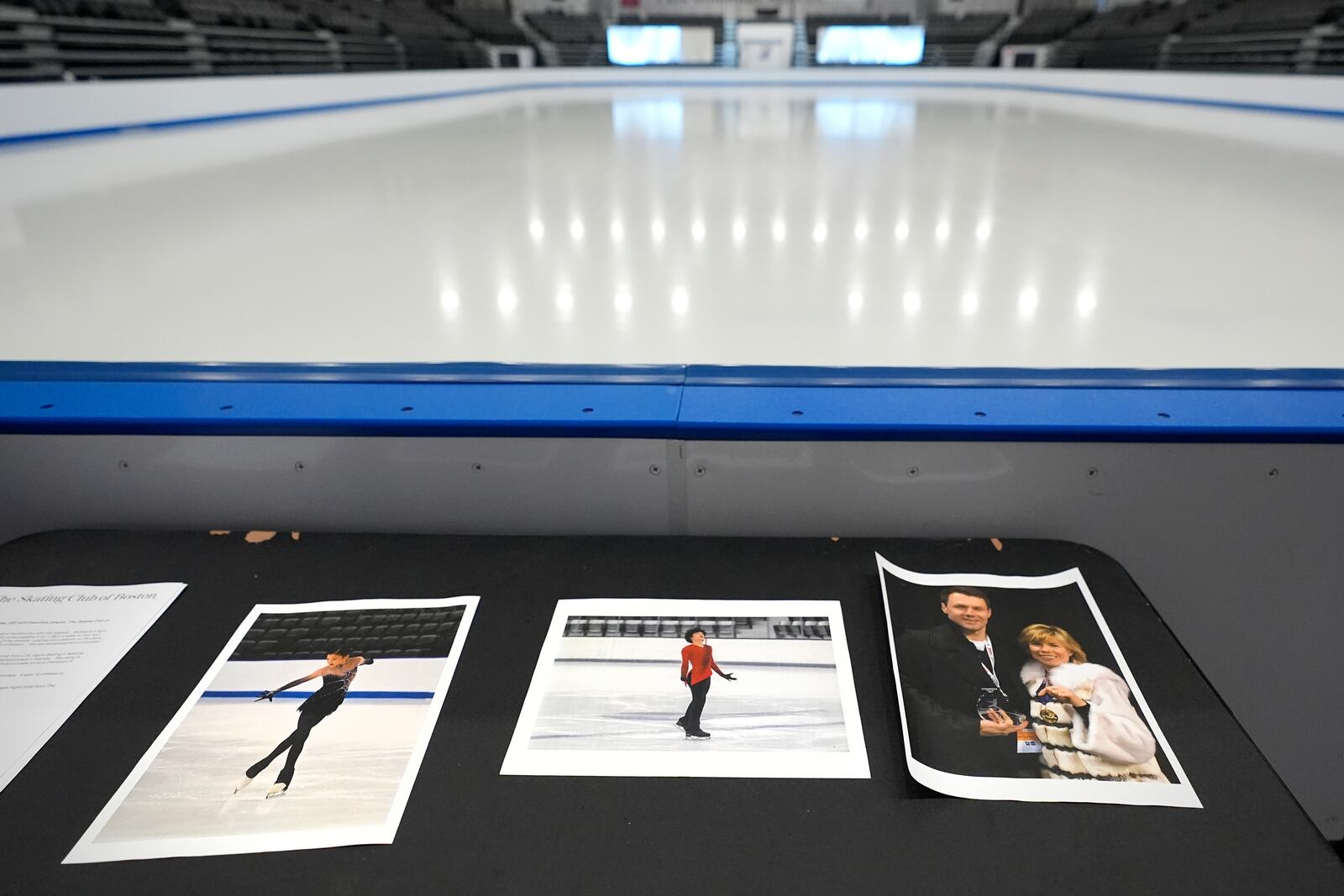 Photographs of aircraft crash victims from The Skating Club of Boston rink are displayed rink side, Thursday, Jan. 30, 2025, in Norwood, Mass. From left is skater Jinna Han, skater Spencer Lane and coaches Vadim Naumov and Evgenia Shishkova. (AP Photo/Charles Krupa)