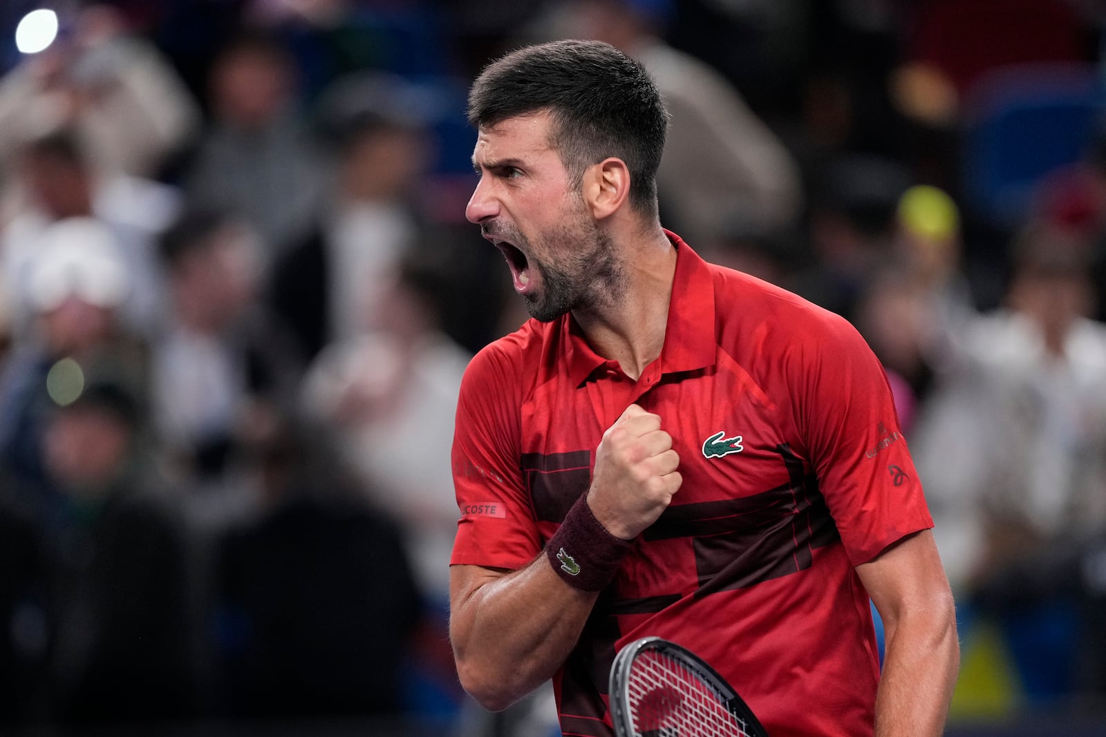 Novak Djokovic of Serbia reacts after defeating Taylor Fritz of the United States in the men's singles semifinals match of the Shanghai Masters tennis tournament at Qizhong Forest Sports City Tennis Center in Shanghai, China, Saturday, Oct. 12, 2024. (AP Photo/Andy Wong)