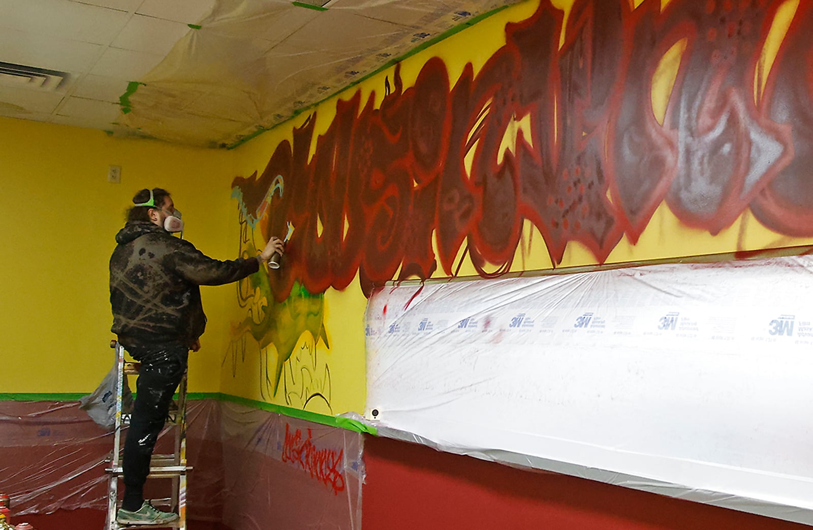 Artist Tyler Abston works on a mural in the lobby of the new Cousin Vinney's Pizza in the Western Plaza Shopping Center Thursday, Jan. 18, 2024. The new pizza shop officially opens on Monday. BILL LACKEY/STAFF