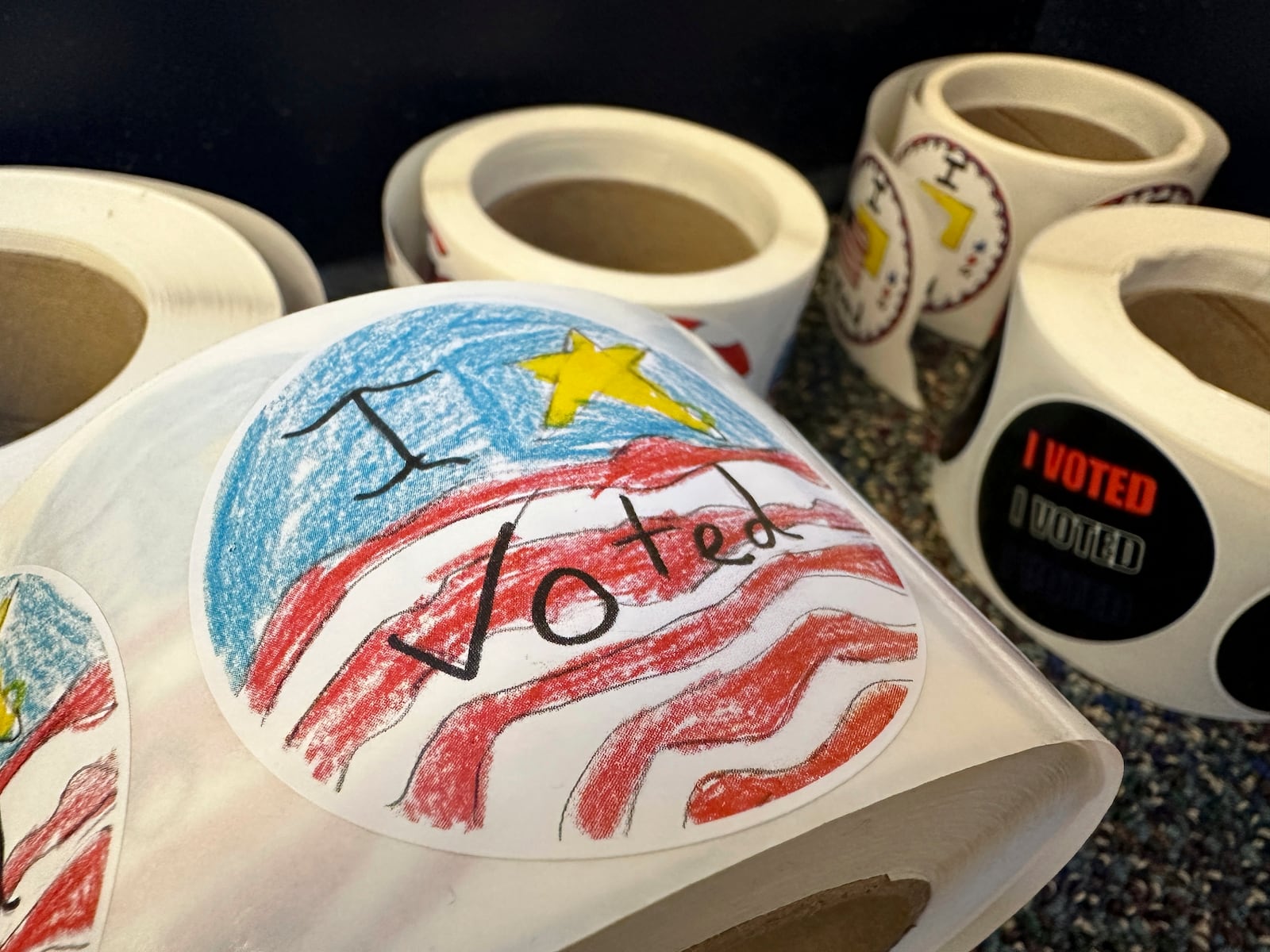 Rolls of I Voted stickers that were designed by students as part of a contest are stacked at a voting center in Albuquerque, N.M., on Wednesday, Oct. 30, 2024. (AP Photo/Susan Montoya Bryan)