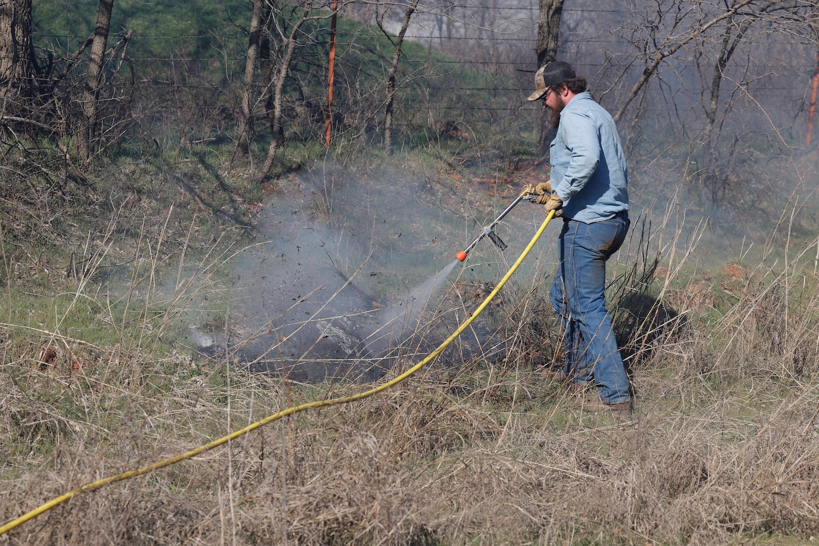 Fire crews and volunteers battle hot spots and new fires several miles west of Stillwater, Okla., Monday, March 17, 2025. (AP Photo/Alonzo Adams)