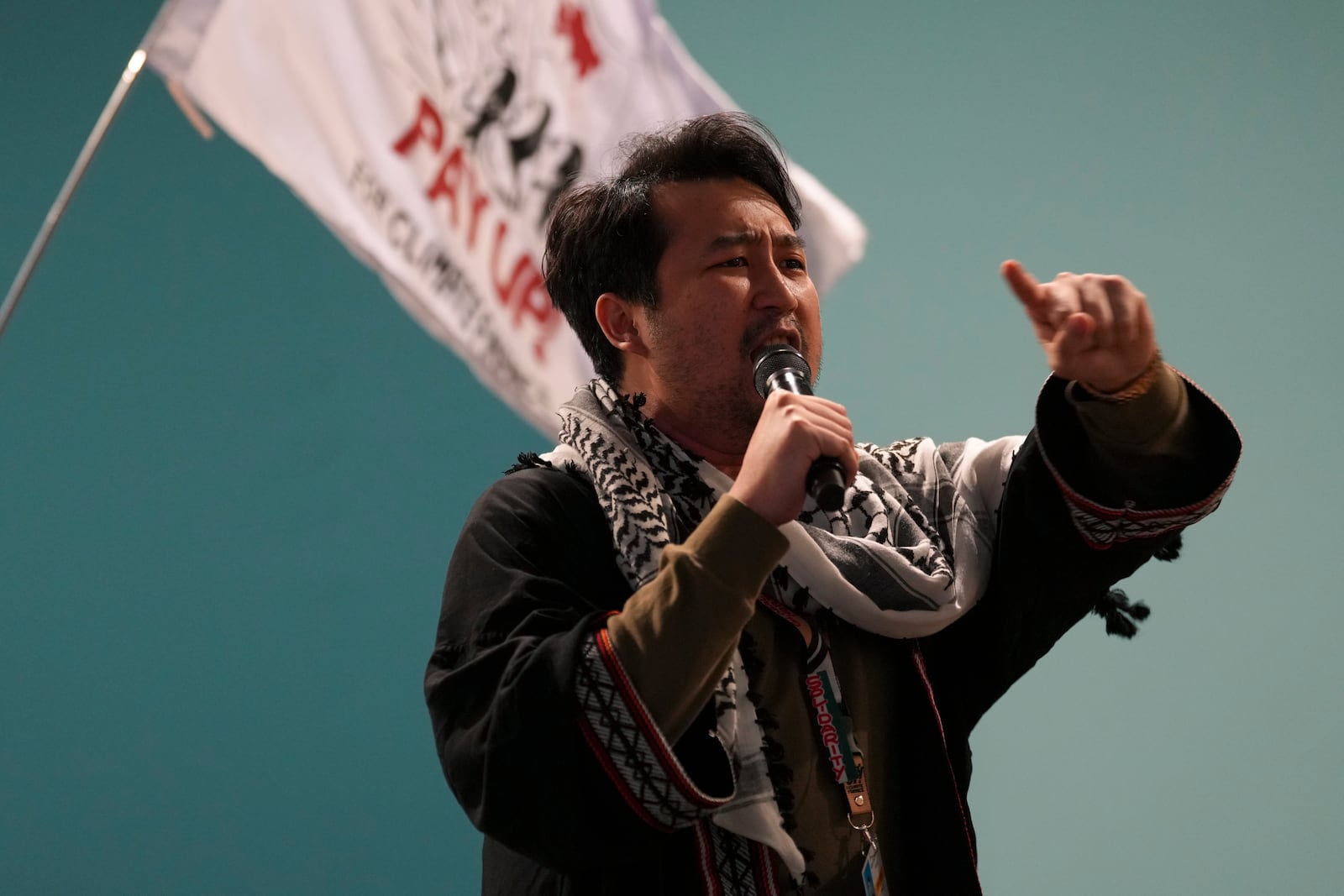 Raphael Abacan leads a demonstration during the COP29 U.N. Climate Summit, Saturday, Nov. 16, 2024, in Baku, Azerbaijan. (AP Photo/Peter Dejong)