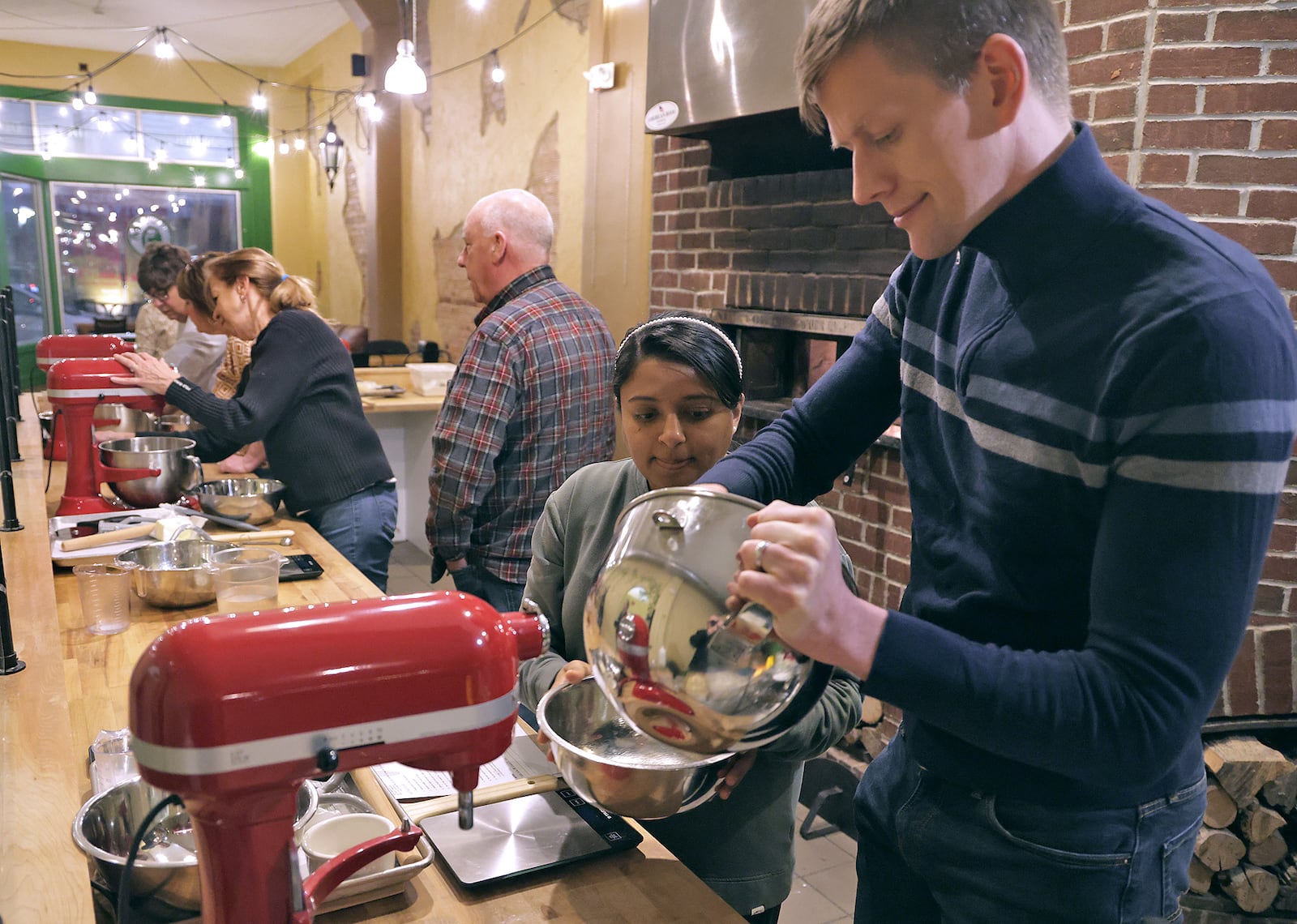 Geoffrey and Meetal Reed participate in the cooking class at Le Torte Dolci Bakery in Springfield Friday, Jan. 31, 2025. BILL LACKEY/STAFF