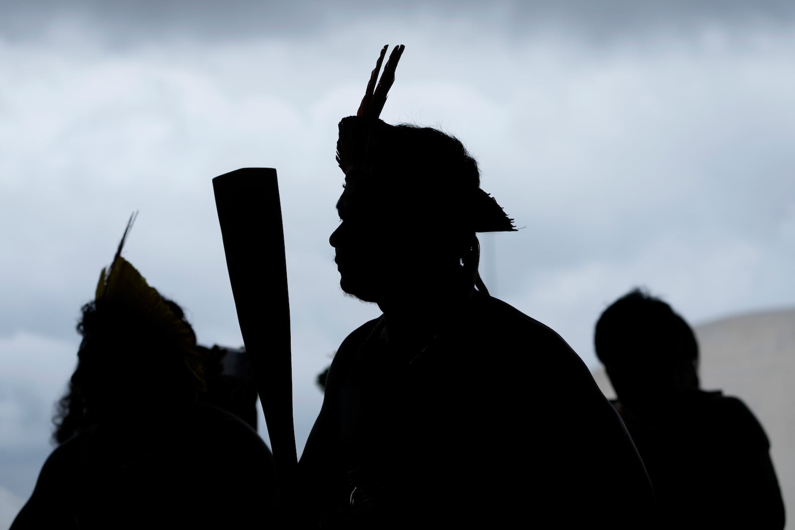 Indigenous people perform a ceremonial dance during a protest against the prospective creation of a benchmark time limit that threatens to strip some of their lands, in Brasilia, Brazil, Wednesday, Oct. 30, 2024. (AP Photo/Eraldo Peres)