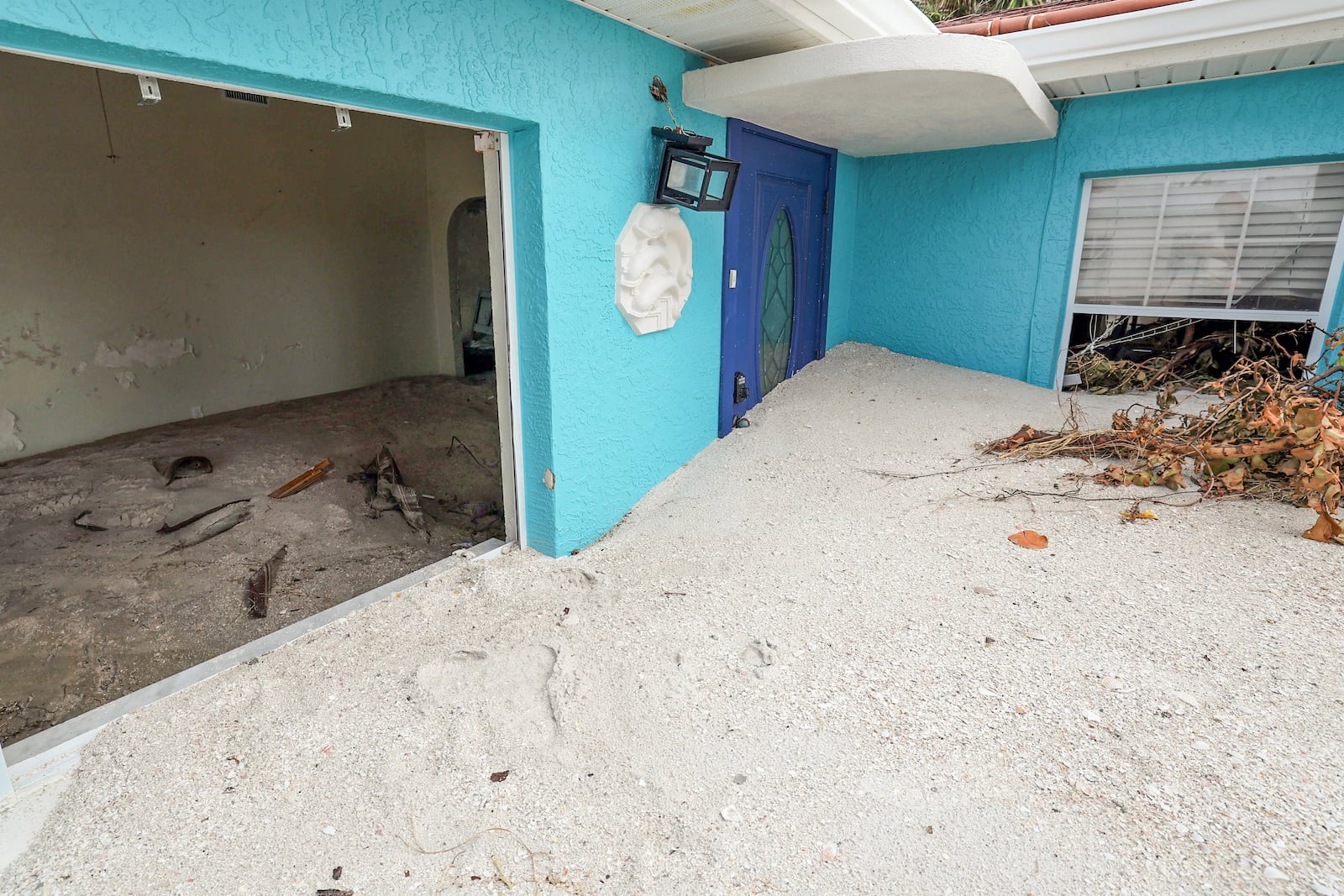 FILE - Sand washed ashore by the surge of Hurricane Helene fills a house, Oct. 2, 2024, in Treasure Island, Fla. (AP Photo/Mike Carlson, File)