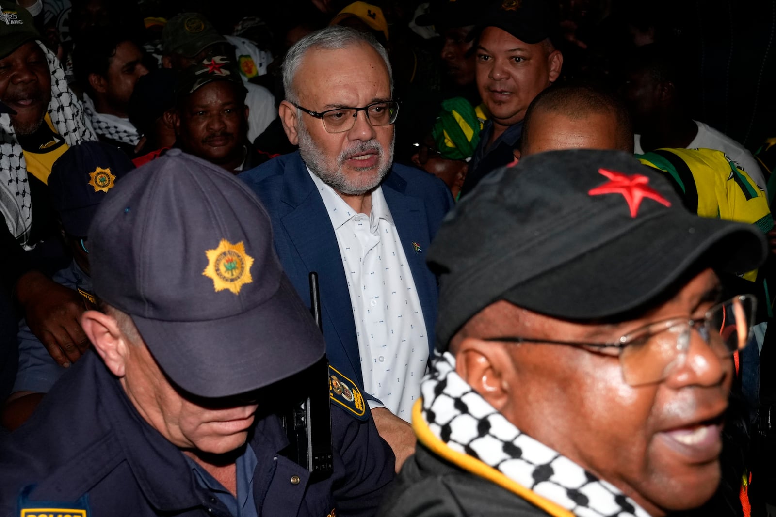 Expelled South Africa Ambassador Ebrahim Rasool is greeted by supporters following his arrival, at Cape Town International Airport in Cape Town, South Africa, Sunday, March 23, 2025. (AP Photo/Nardus Engelbrecht)