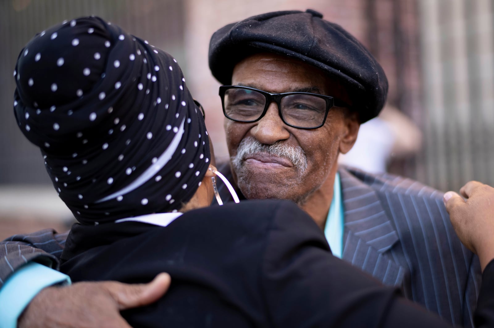 Herbert Rice, 79, right, is embraced by Adrianne Jones-Alston, on Wednesday, Oct. 23, 2024, in Philadelphia. (AP Photo/Laurence Kesterson)