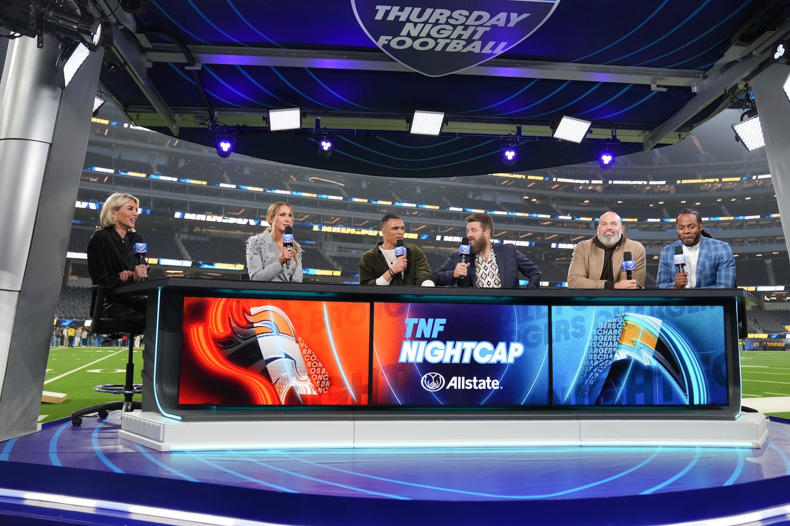 Nikki Glaser, second from left, participates in a segment with the Thursday Night Football crew after an NFL football game between the Los Angeles Chargers and the Denver Broncos, Thursday, Dec. 19, 2024, in Inglewood, Calif. (AP Photo/Eric Thayer)