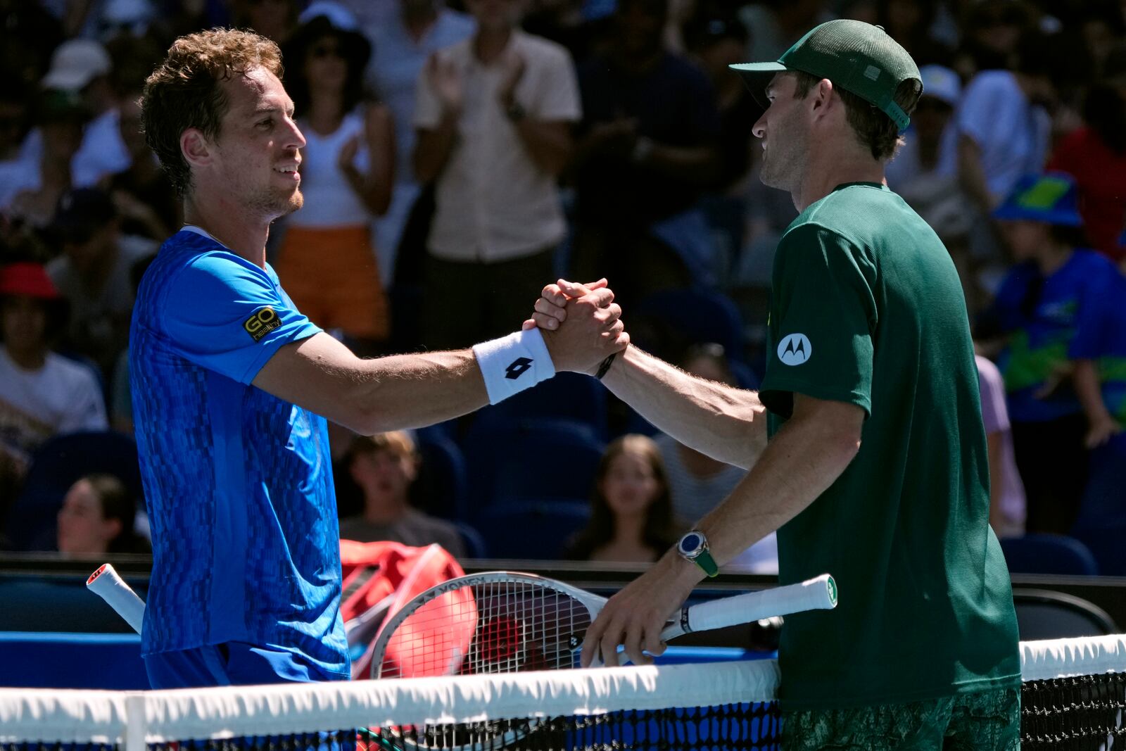 Tommy Paul, right, of the U.S. is congratulated by Roberto Carballes Baena of Spain following their third round match at the Australian Open tennis championship in Melbourne, Australia, Friday, Jan. 17, 2025. (AP Photo/Manish Swarup)