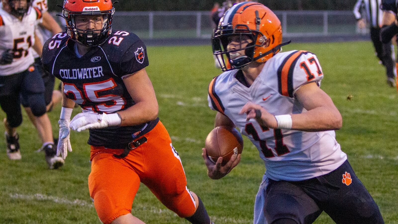 Versailles quarterback Michael Osborne runs for a first down on the game's opening drive Friday night at Coldwater. Jeff Gilbert/CONTRIBUTED