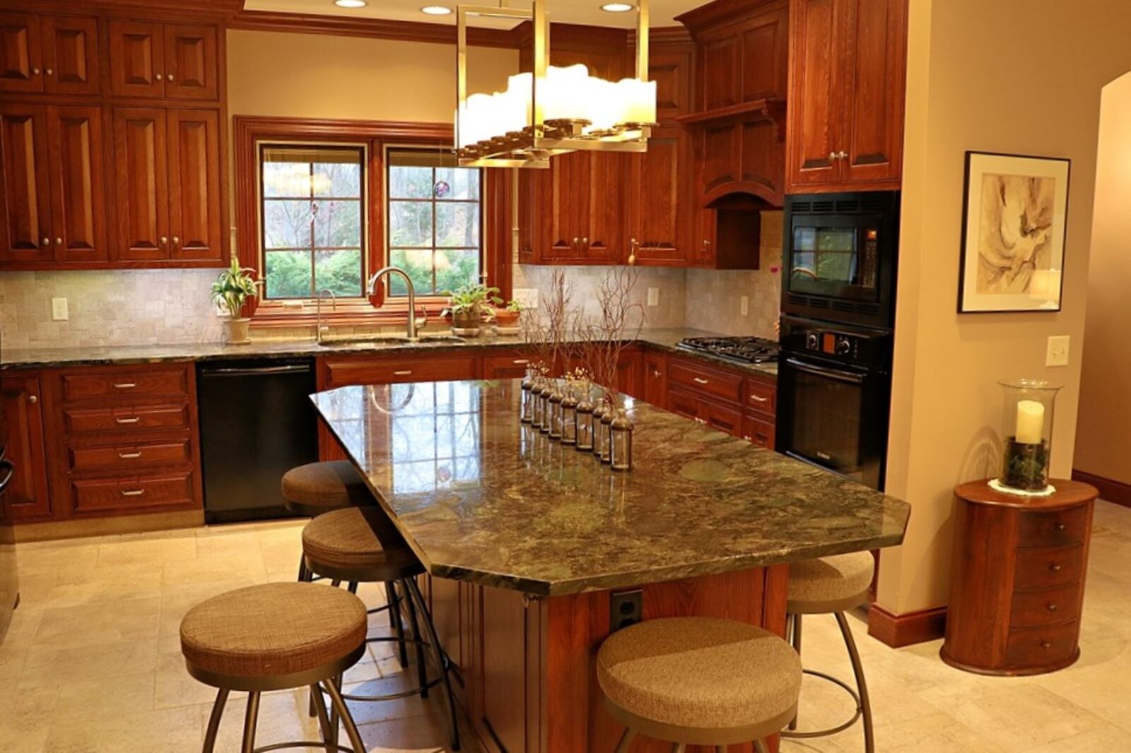 A large granite island allows for additional workspace and seating in the kitchen.