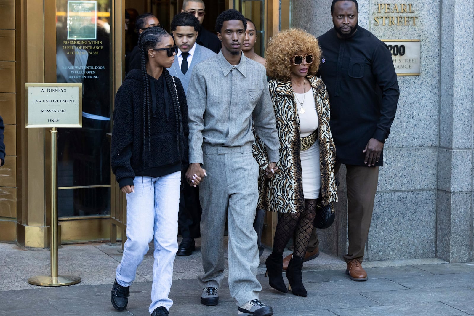 Janice Combs, right, King Combs, center, and D'Lila Combs and Jessie Combs, twin daughters of Sean "Diddy Combs, exit Manhattan federal court, Thursday, Oct. 10 2024, in New York. (AP Photo/Yuki Iwamura)