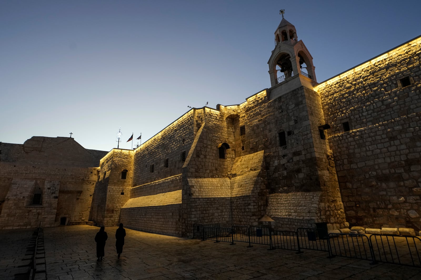 Nuns walk along the Church of the Nativity, traditionally believed to be the birthplace of Jesus, on Christmas Eve, in the West Bank city of Bethlehem, Tuesday, Dec. 24, 2024. (AP Photo/Matias Delacroix)