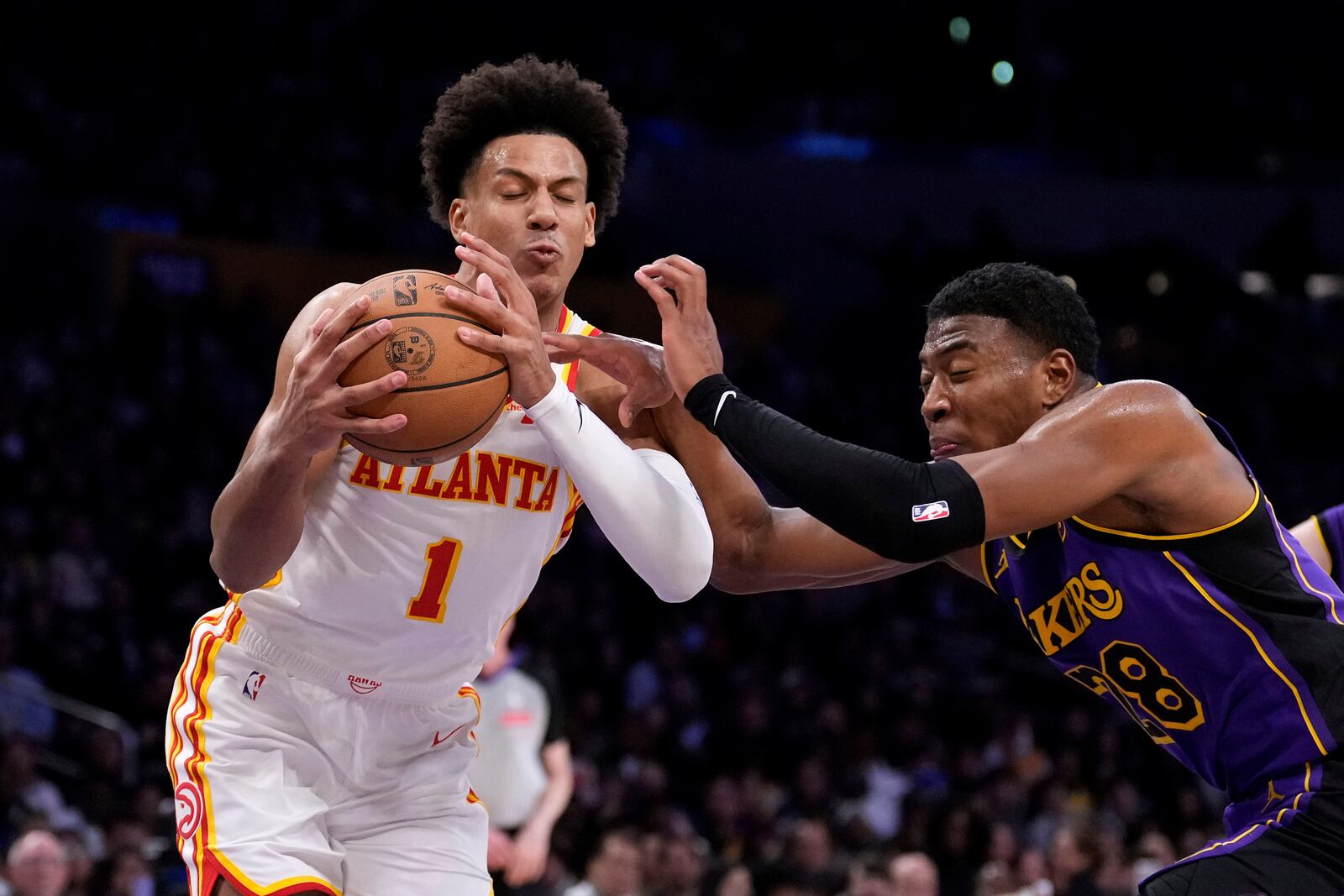 Atlanta Hawks forward Jalen Johnson, left, tries to shoot as Los Angeles Lakers forward Rui Hachimura defends during the second half of an NBA basketball game, Friday, Jan. 3, 2025, in Los Angeles. (AP Photo/Mark J. Terrill)