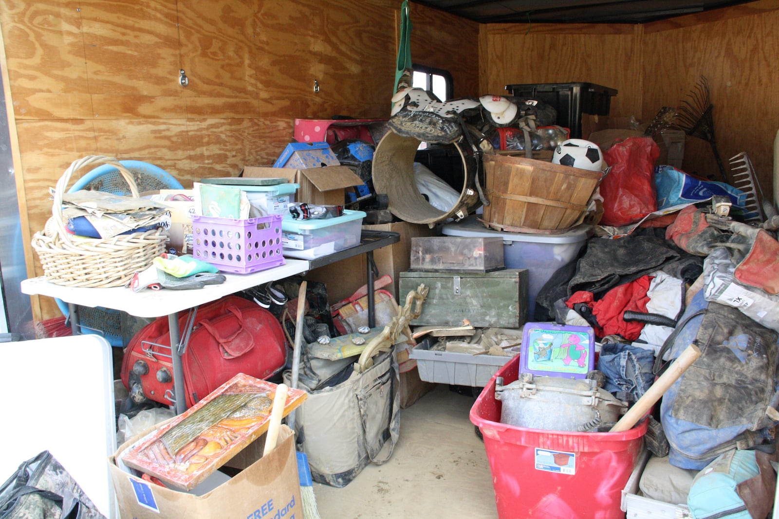 Items found by Jill Holtz on her searches amid the rubble from Hurricane Helene are stacked inside her trailer in Swannanoa, N.C., on Thursday, Feb. 6, 2025. (AP Photo/Makiya Seminera)