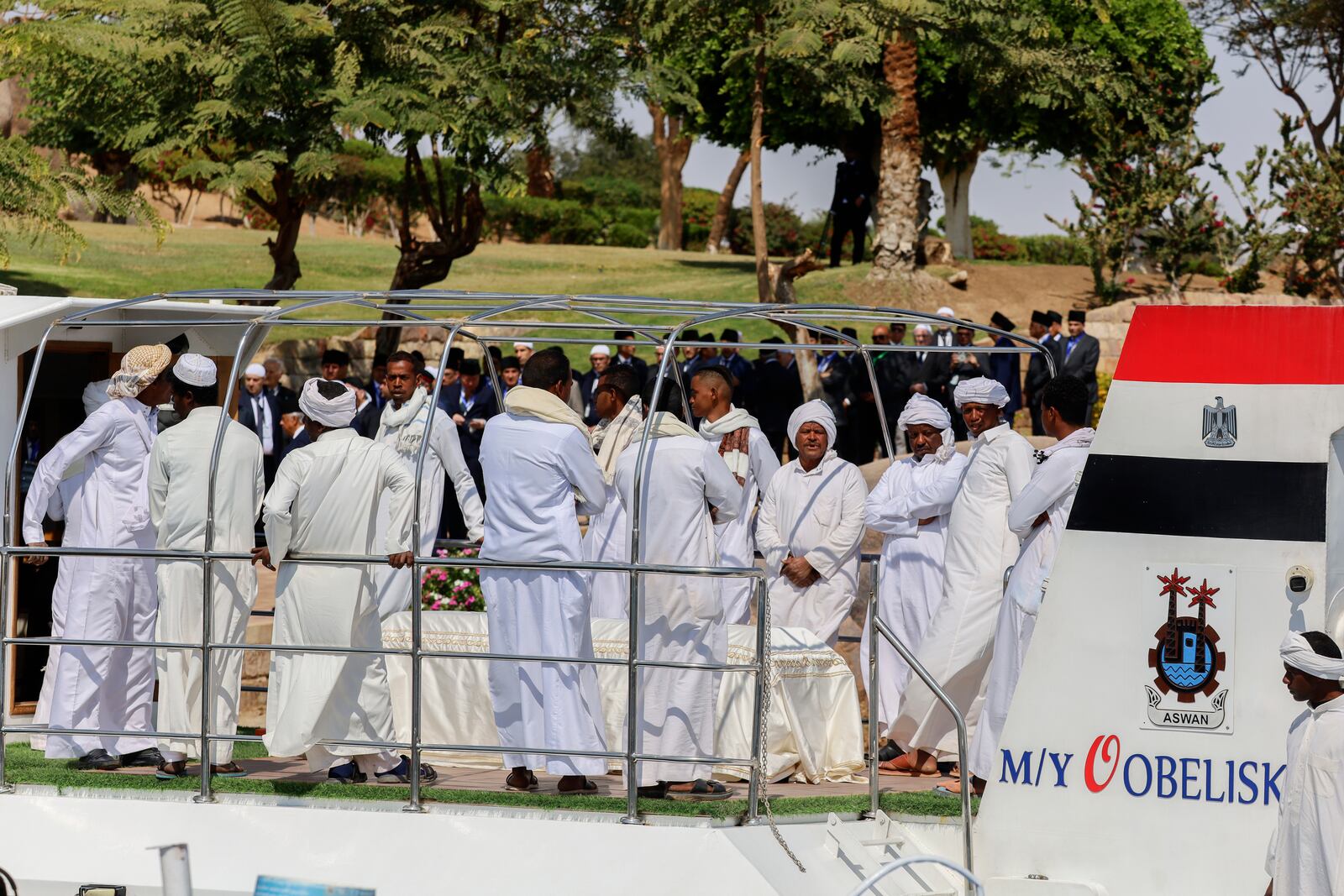 People surround the coffin of Prince Karim Al-Hussaini, the Aga Khan IV and 49th hereditary imam of the Shiite Ismaili Muslims, who died Tuesday in Portugal, to be buried at the Aga Khan mausoleum, in Aswan, Egypt, Sunday, Feb. 9, 2025. (AP Photo/Haytham Fahmy)