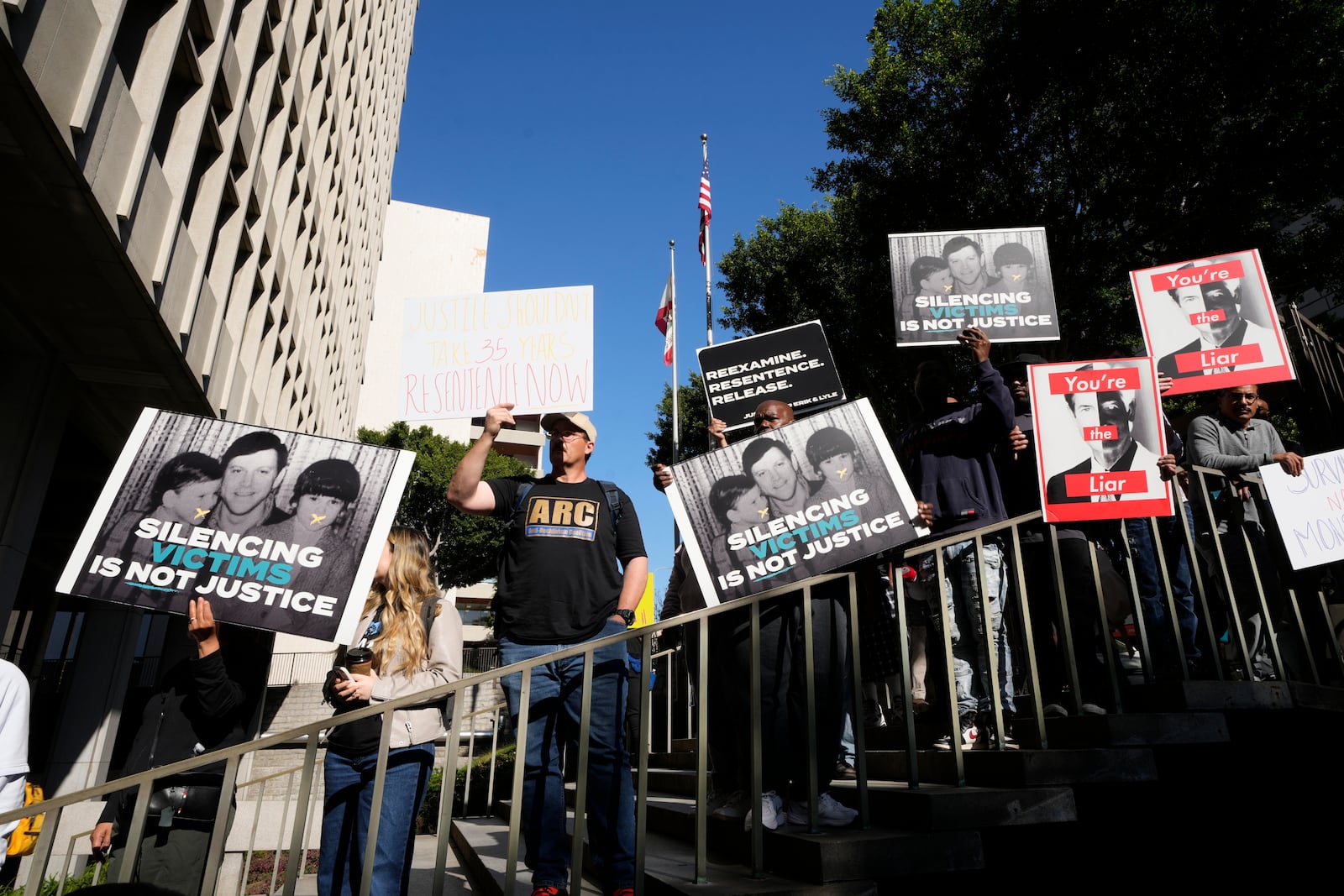 Supporters hold signs during a press conference regarding developments in the Menendez brothers case Thursday, March 20, 2025, in Los Angeles. (AP Photo/Damian Dovarganes)