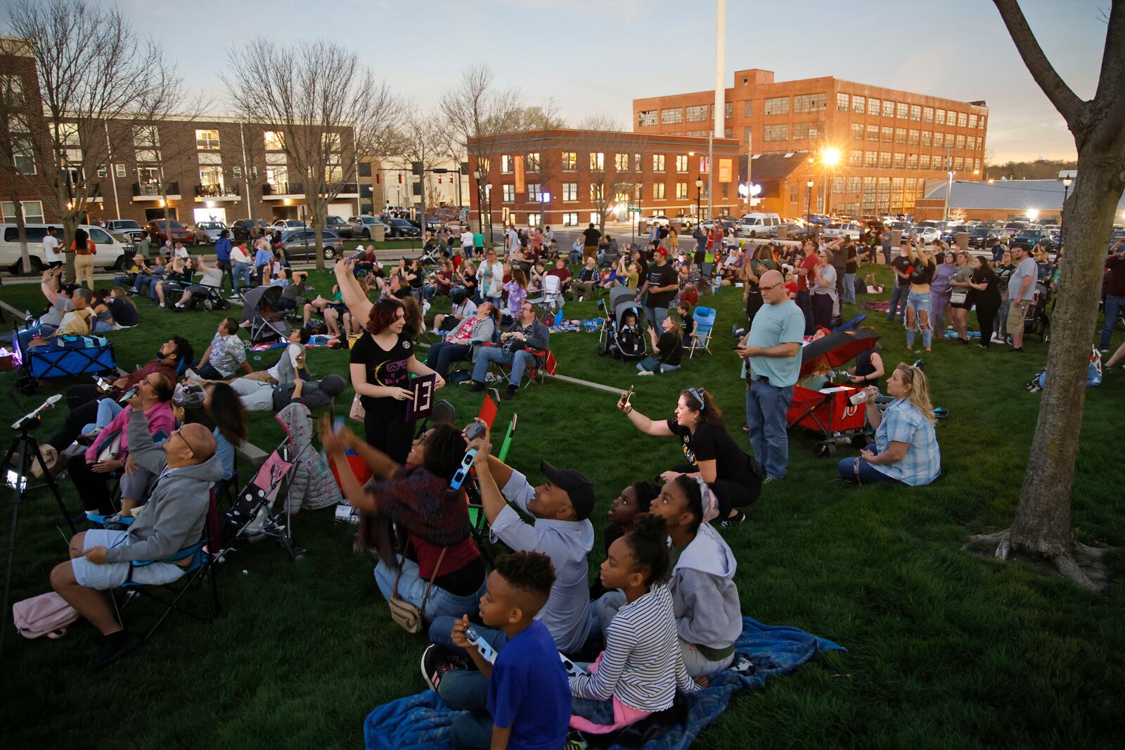 The crowd at National Road Commons Park watch the total eclipse Monday, April 8, 2024. BILL LACKEY/STAFF