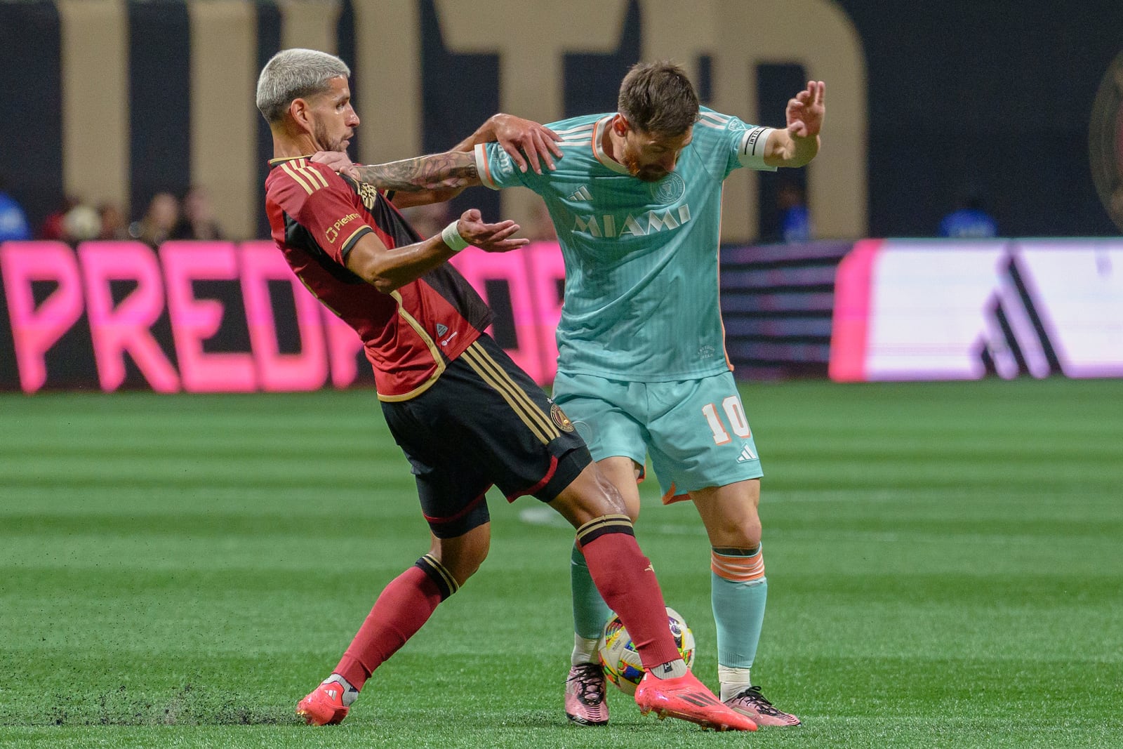 Inter Miami forward Lionel Messi (10) attempts to maintain the ball during the first half of an MLS soccer match against Atlanta United, Saturday, Nov. 2, 2024, in Atlanta. (AP Photo/Jason Allen)