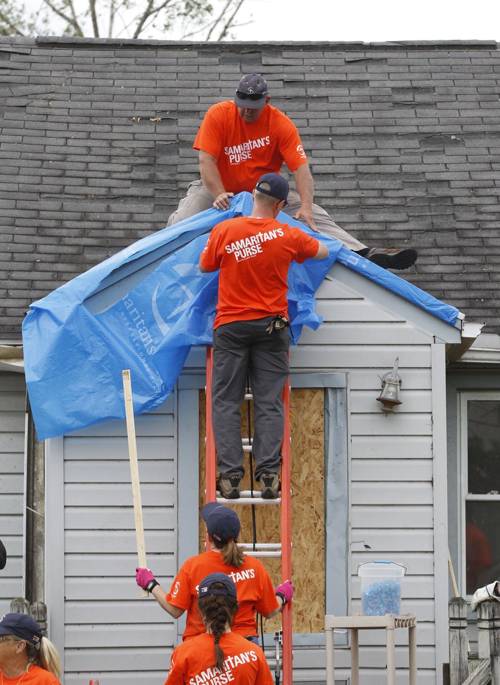 Volunteers with Samaritan’s Purse worked in this Harrison Twp. neighborhood and others that were affected by tornado damage. TY GREENLEES / STAFF