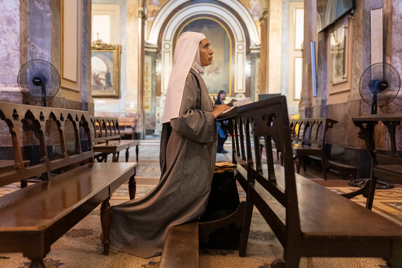 Missionary nun Maria Engracia, from Mexico, prays for the health of Pope Francis at the Metropolitan Cathedral in Buenos Aires, Buenos Aires, Argentina, Friday, Feb. 21, 2025. (AP Photo/Rodrigo Abd)