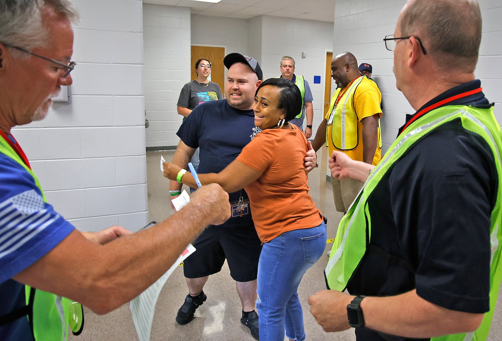 Brad Minerd, playing the part of a parent, hugs Camille Rucker, playing the part of his daughter and a student, as they're reunited during a reunification training session at Springfield High School Wednesday, June 5, 2024. Most of the Clark County schools along with law enforcement and fire personel participated in the training about getting students back with their parents after an emergency situation.