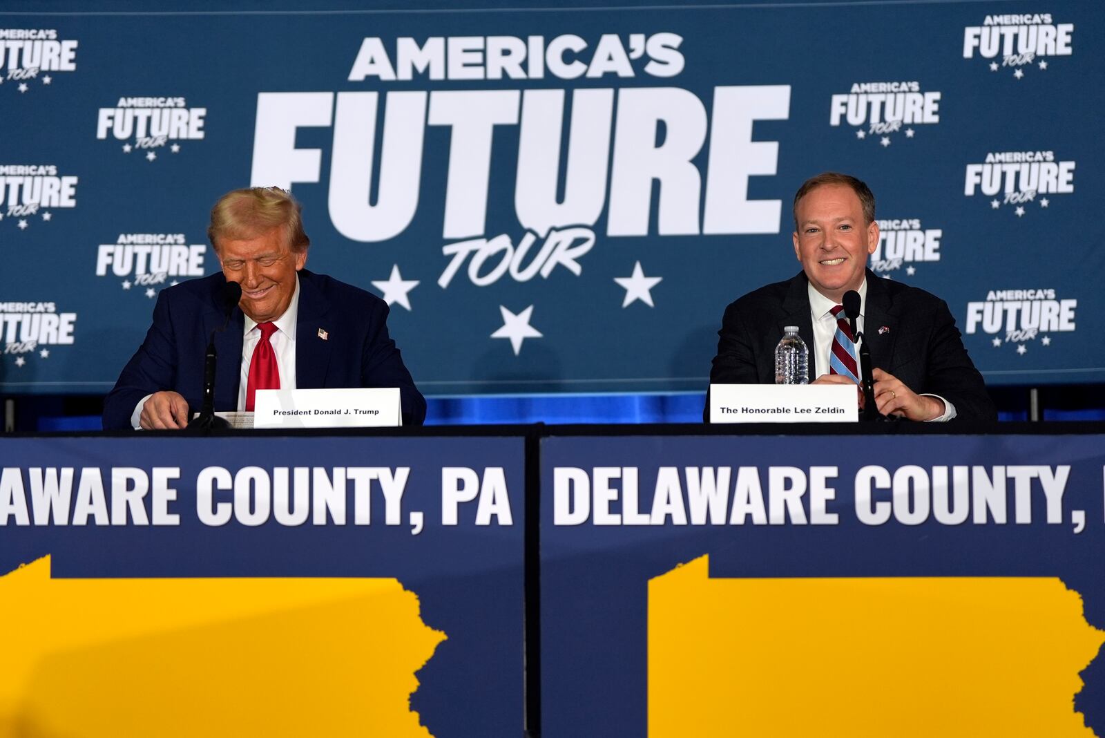 Republican presidential nominee former President Donald Trump smiles as former Rep. Lee Zelda, R-N.Y., watches during a roundtable at the Drexelbrook Catering & Event Center, Tuesday, Oct. 29, 2024, in Drexel Hill, Pa. (AP Photo/Julia Demaree Nikhinson)