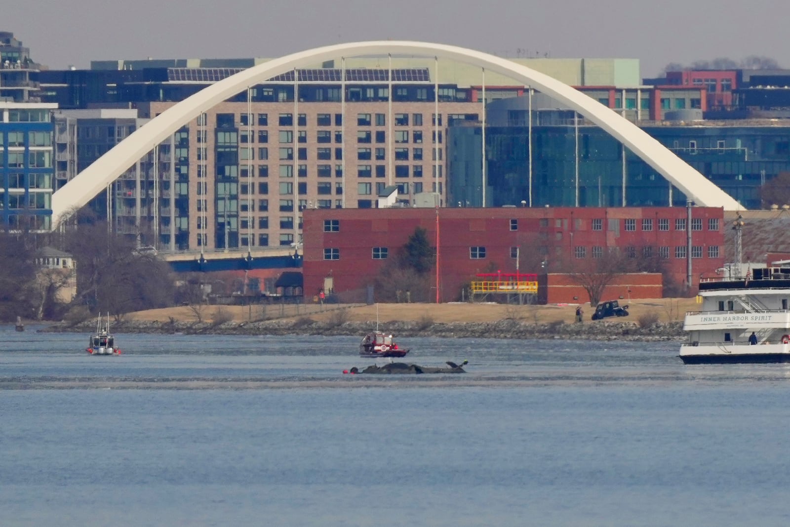 Search and rescue efforts are seen around a wreckage site in the Potomac River from Ronald Reagan Washington National Airport, early Thursday morning, Jan. 30, 2025, in Arlington, Va. (AP Photo/Carolyn Kaster)