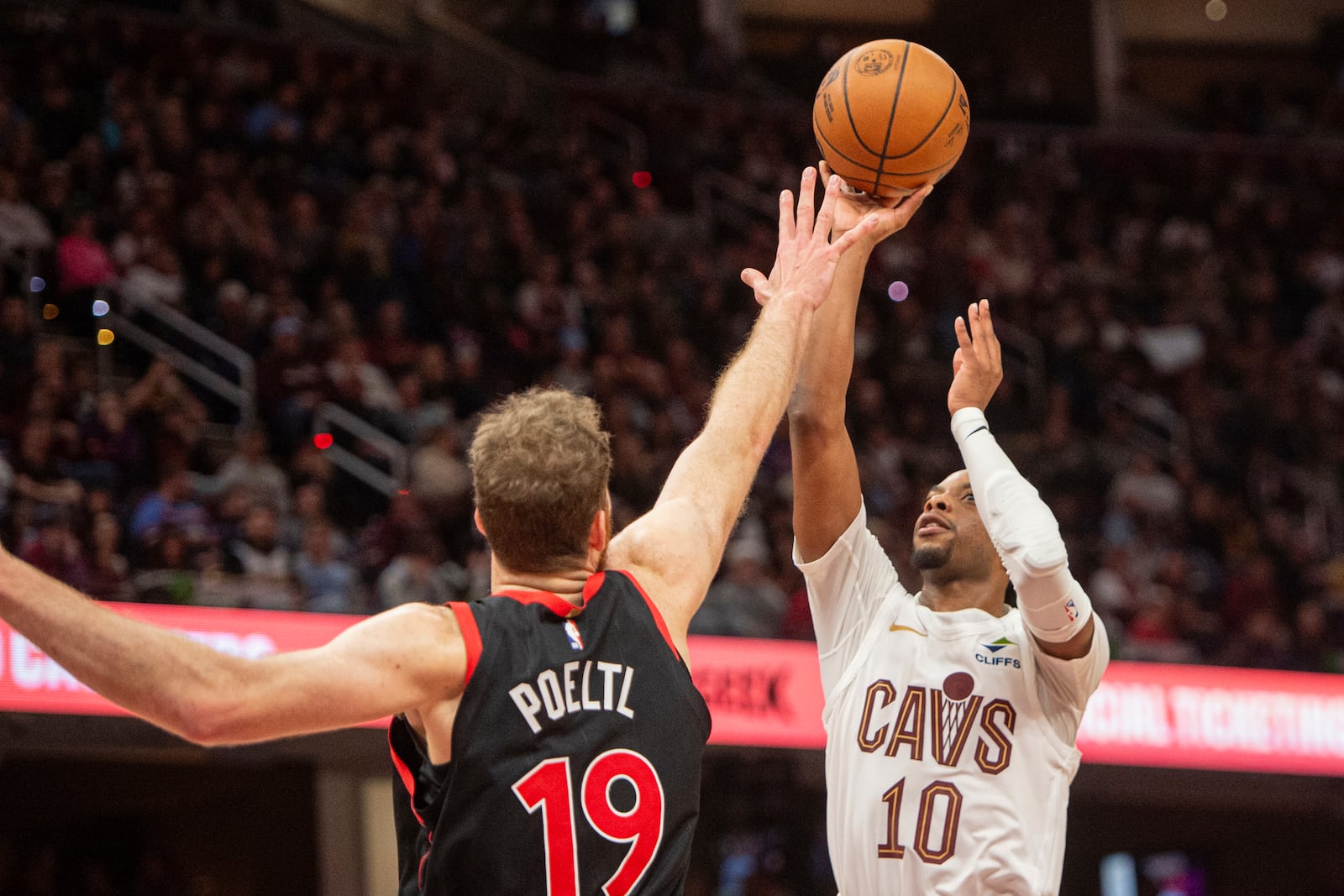 Cleveland Cavaliers' Darius Garland (10) shoots over Toronto Raptors' Jakob Poeltl (19) during the second half of an NBA basketball game in Cleveland, Sunday, Nov 24, 2024. (AP Photo/Phil Long)