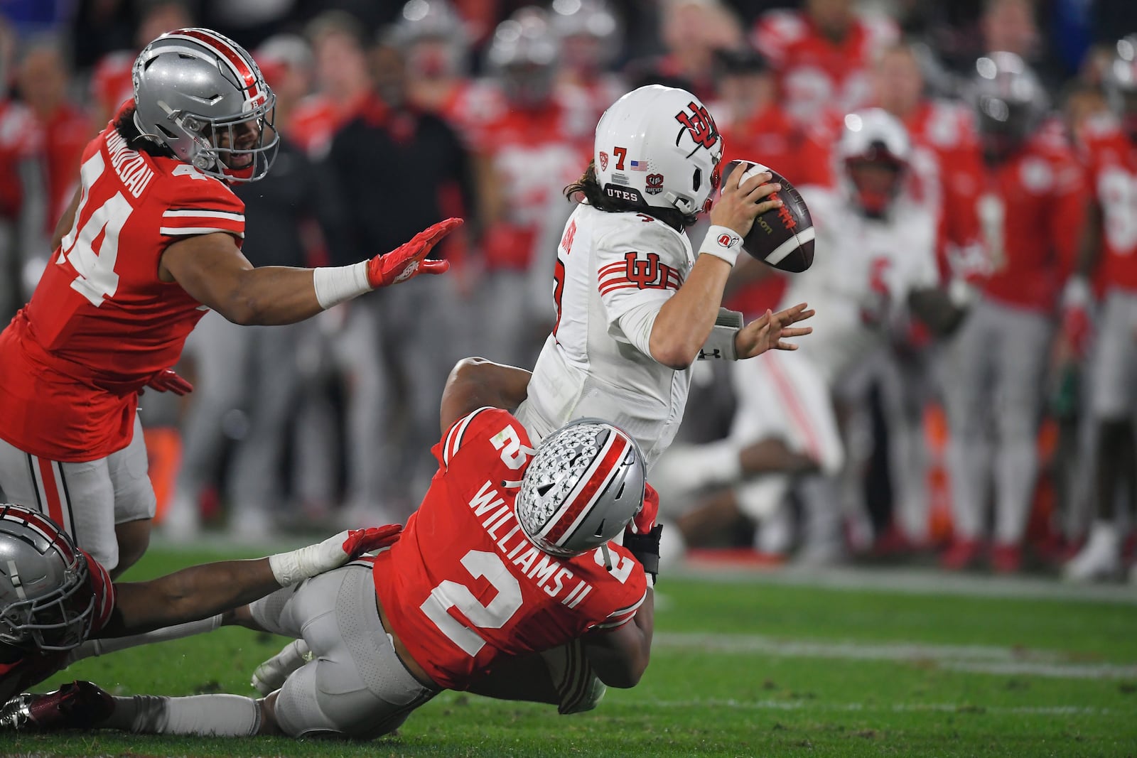 Utah quarterback Cameron Rising, top, is tackled by Ohio State safety Kourt Williams II (2) during the second half in the Rose Bowl NCAA college football game Saturday, Jan. 1, 2022, in Pasadena, Calif. (AP Photo/John McCoy)