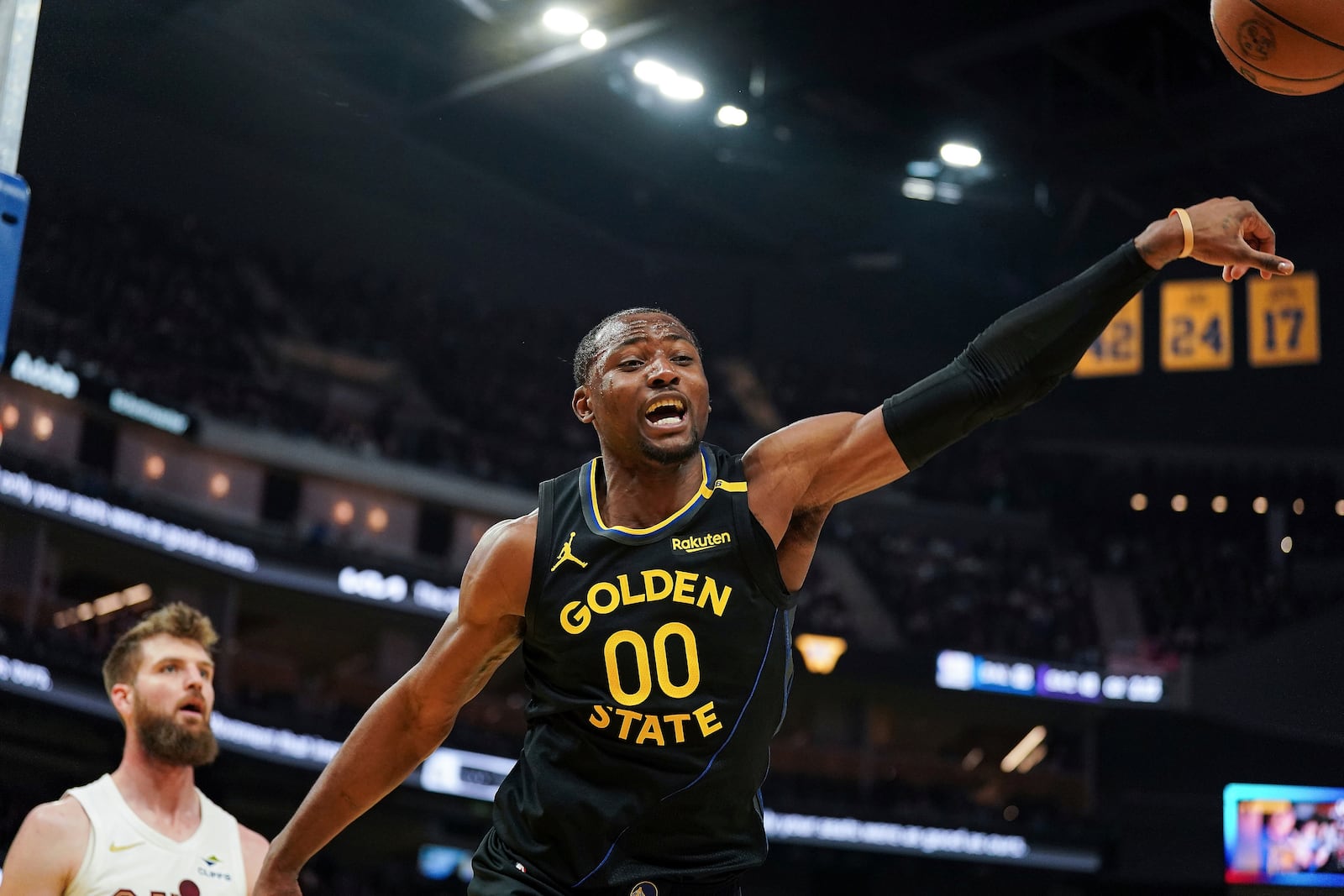 Golden State Warriors forward Jonathan Kuminga (00) reacts after diving forthe ball during the first half of an NBA basketball game against the Cleveland Cavaliers, Monday, Dec. 30, 2024, in San Francisco. (AP Photo/Kavin Mistry)