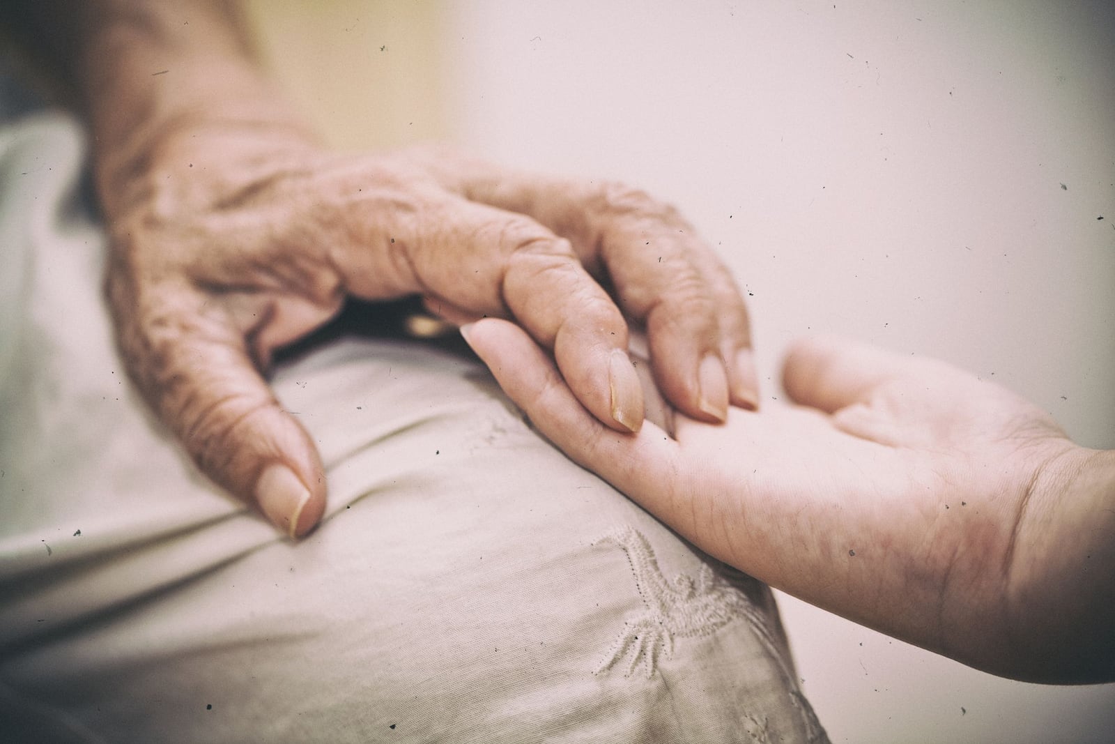 Elderly hand and caregiver