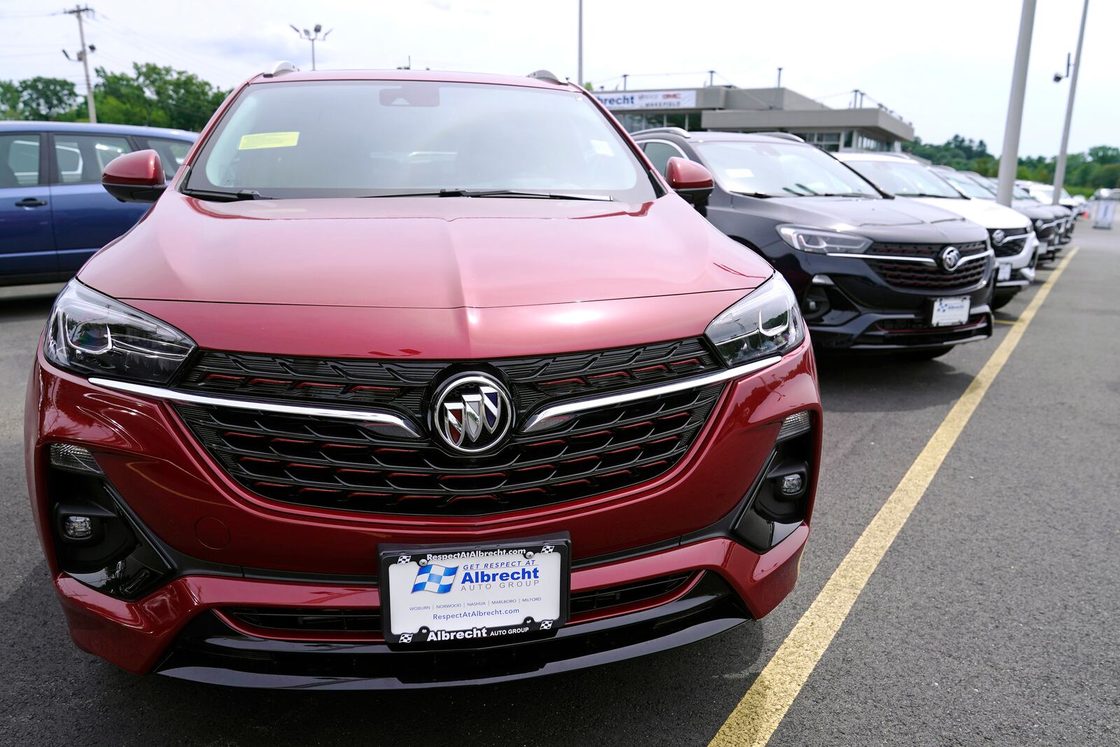 New Buick Encore SUV's displayed on the sales lot at the Albrecht Auto Group dealership, Tuesday, Aug. 3, 2021, in Wakefield, Mass. Prices for U.S. consumers rose in July at the slowest pace since February, a sign that Americans could gain some relief after four months of sharp increases that had elevated inflation to its fastest pace in more than a decade. Most economists agree that the primary drivers of higher prices have been categories of goods and services that were most disrupted by the pandemic, from new and used vehicles to hotel rooms, airline tickets and building materials. (AP Photo/Charles Krupa)