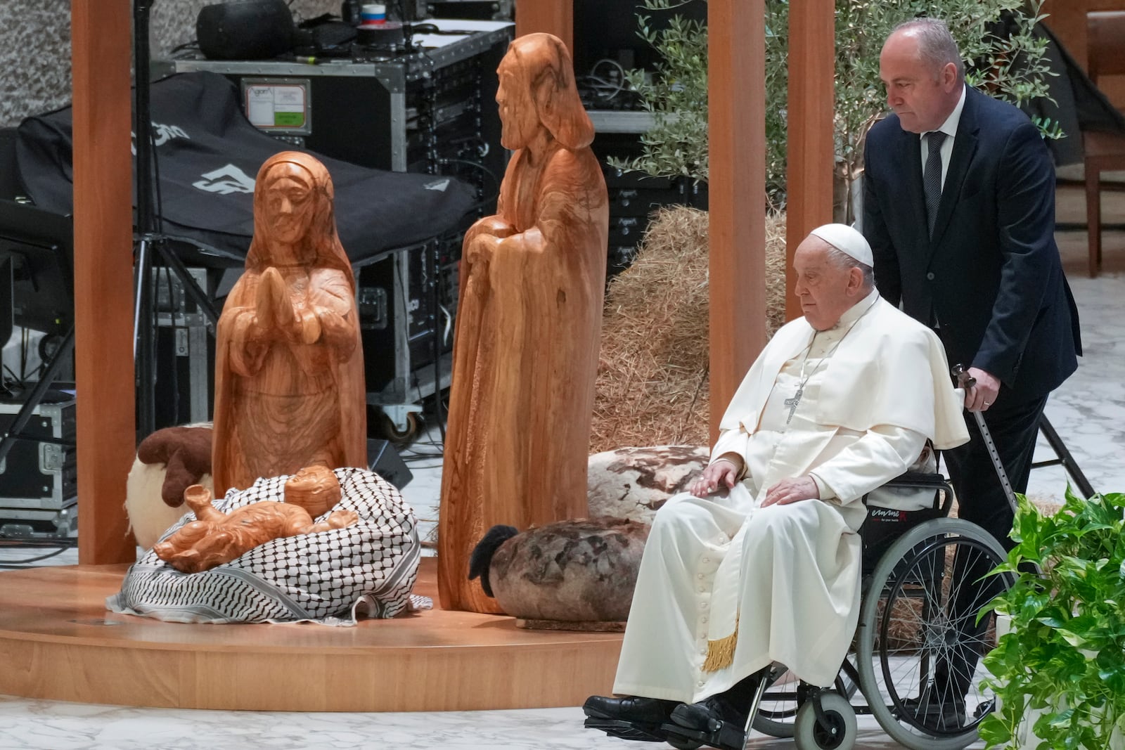 Pope Francis arrives to meet the donors of the fir tree set up in St. Peter's Square as a Christmas tree and those who have crafted the life-size nativity scene at the tree's feet, in the Paul VI hall at the Vatican, Saturday, Dec. 7, 2024. (AP Photo/Andrew Medichini)