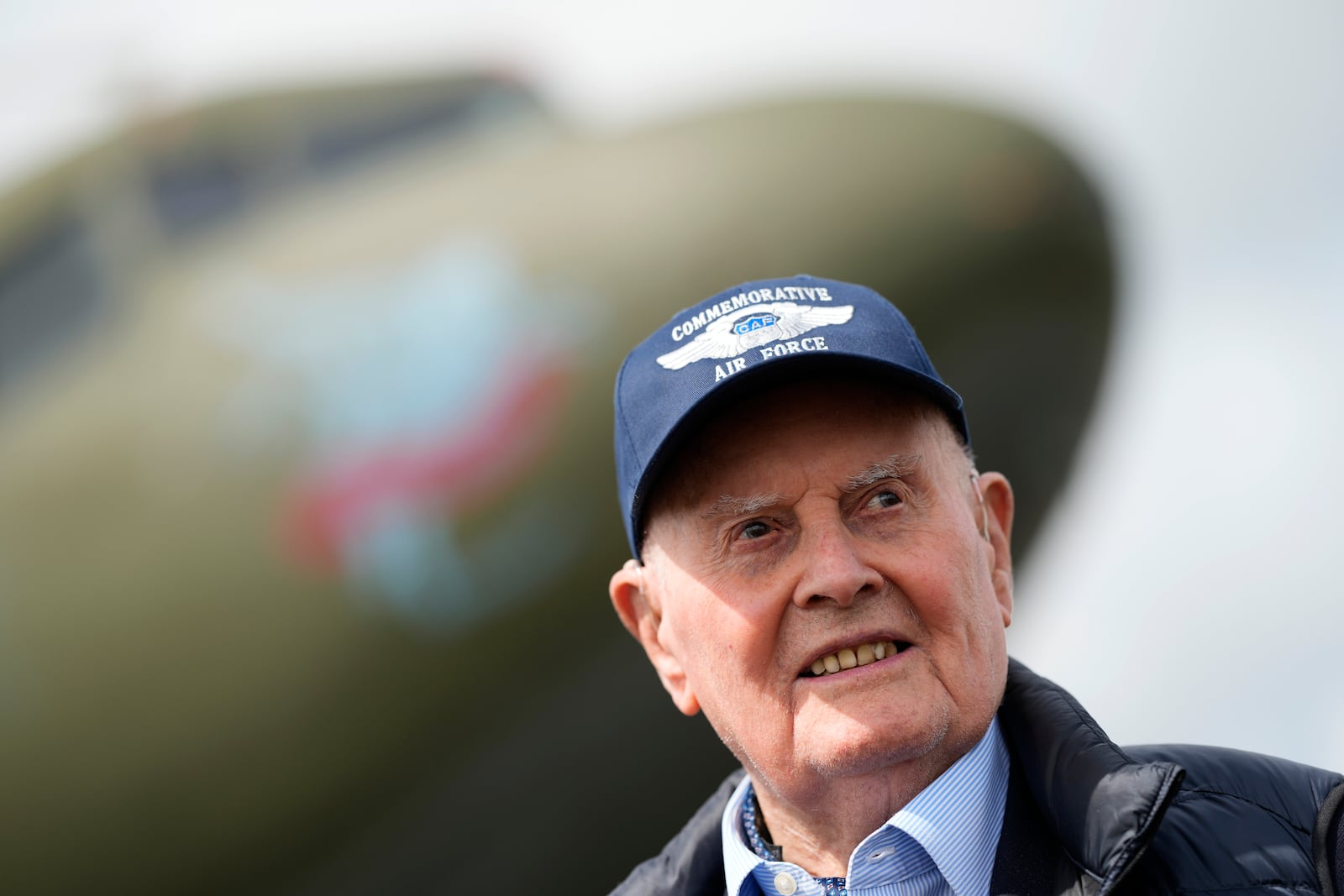 FILE - Veteran Royal Air Force pilot Colin Bell, a 103-year-old former Mosquito pilot who also flew many aircraft across the Atlantic during the war, poses for the media next to a Douglas C-47 Skytrain aircraft, at North Weald airport in North Weald Bassett, England, Thursday, May 16, 2024. (AP Photo/Alastair Grant, File)