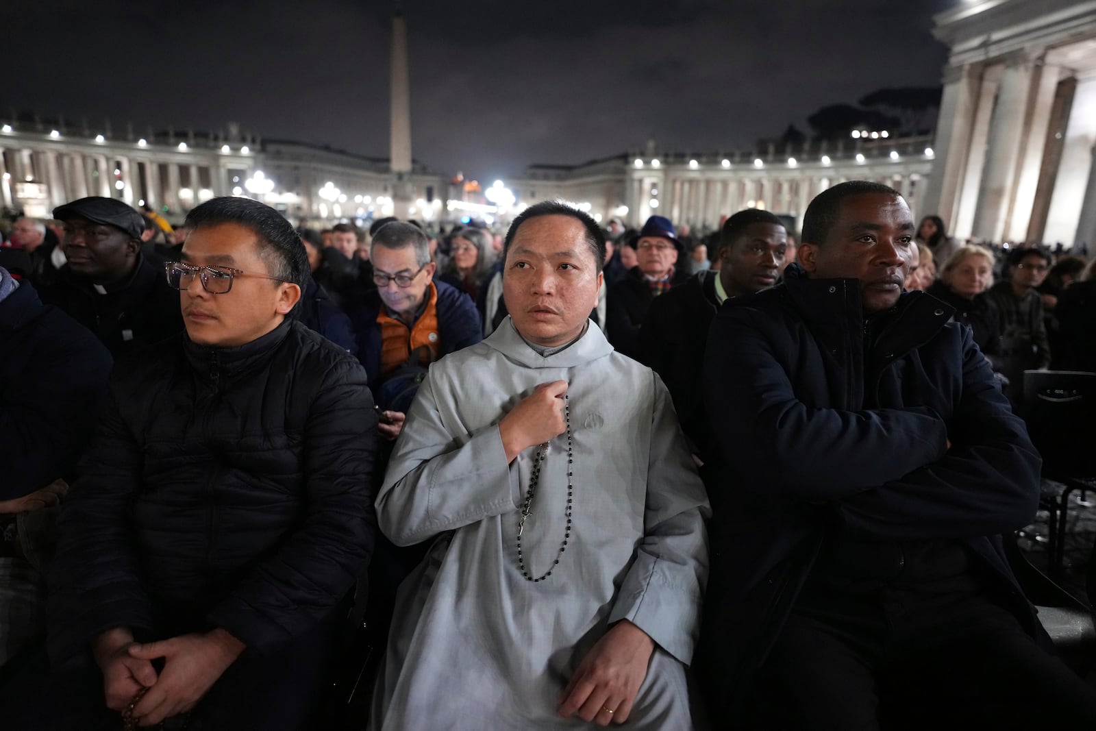 People attend a rosary prayer service with Cardinal Luis Antonio Tagle held for the health of Pope Francis in St Peter's Square at The Vatican, Tuesday, Feb. 25, 2025. (AP Photo/Kirsty Wigglesworth)